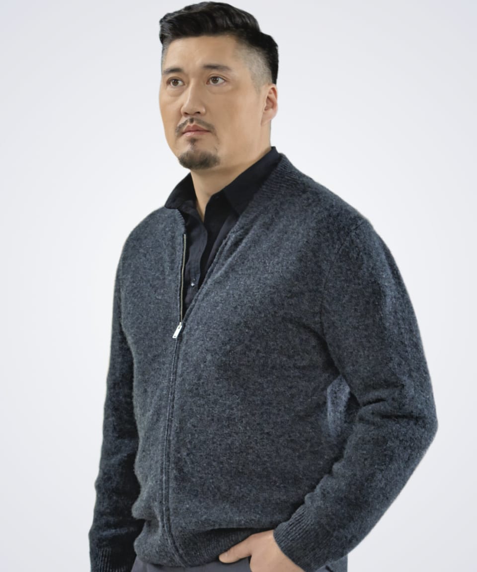 Man wearing a dark grey classic cashmere cardigan with ribbed details, front view