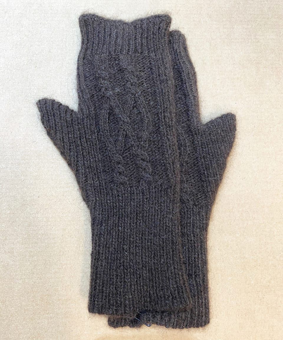 Dark brown yak wool hand warmers on neutral background, flat view