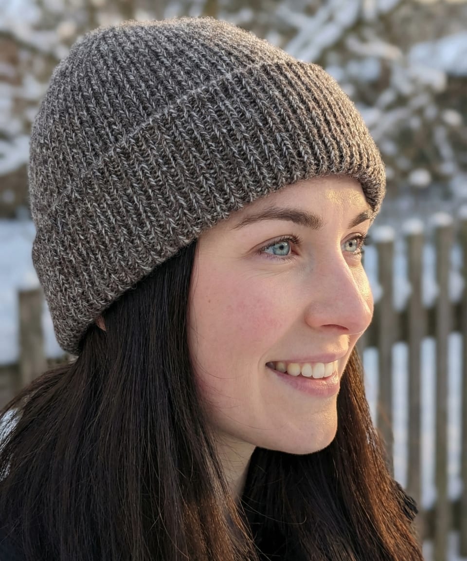 Woman outdoors wearing a mottled brown-white ribbed yak wool hat