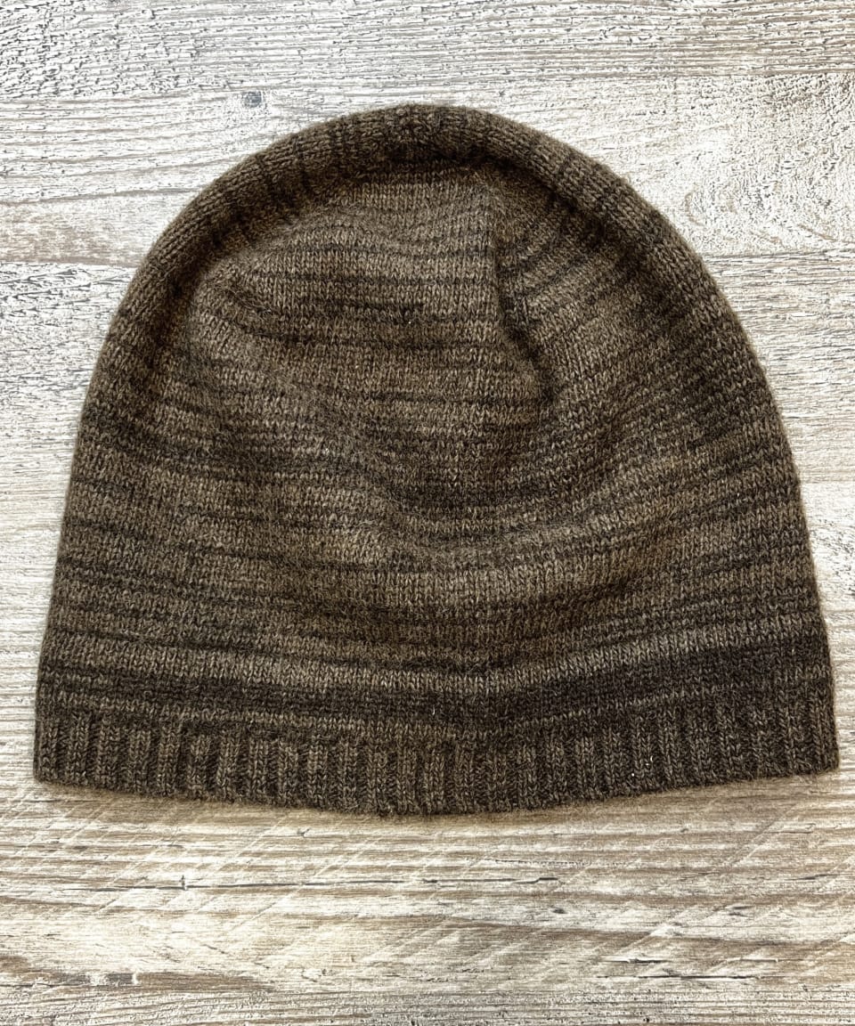 Mottled brown yak wool beanie on neutral background, flat view