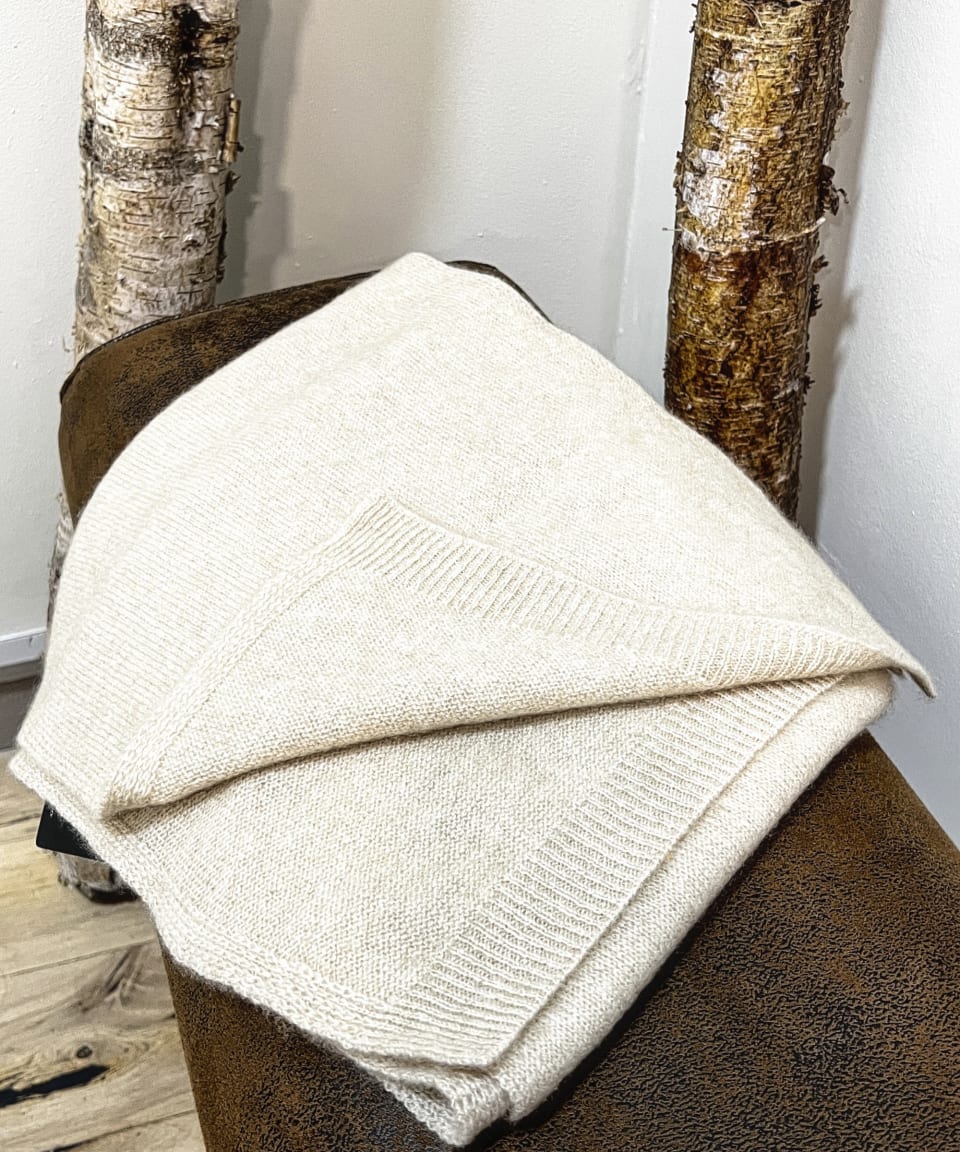 Natural beige cashmere scarf on neutral background, flat view