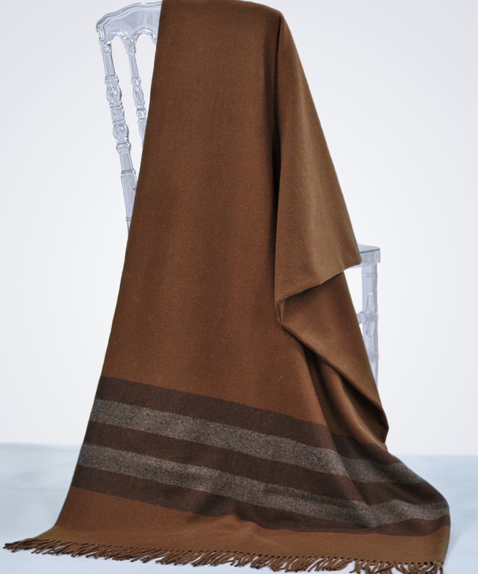 brown cashmere blanket draped over a chair