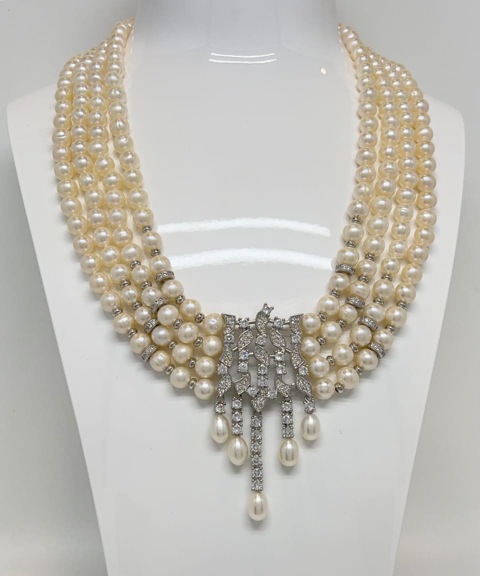 Classic four-strand layered pearl necklace with crystal pendants