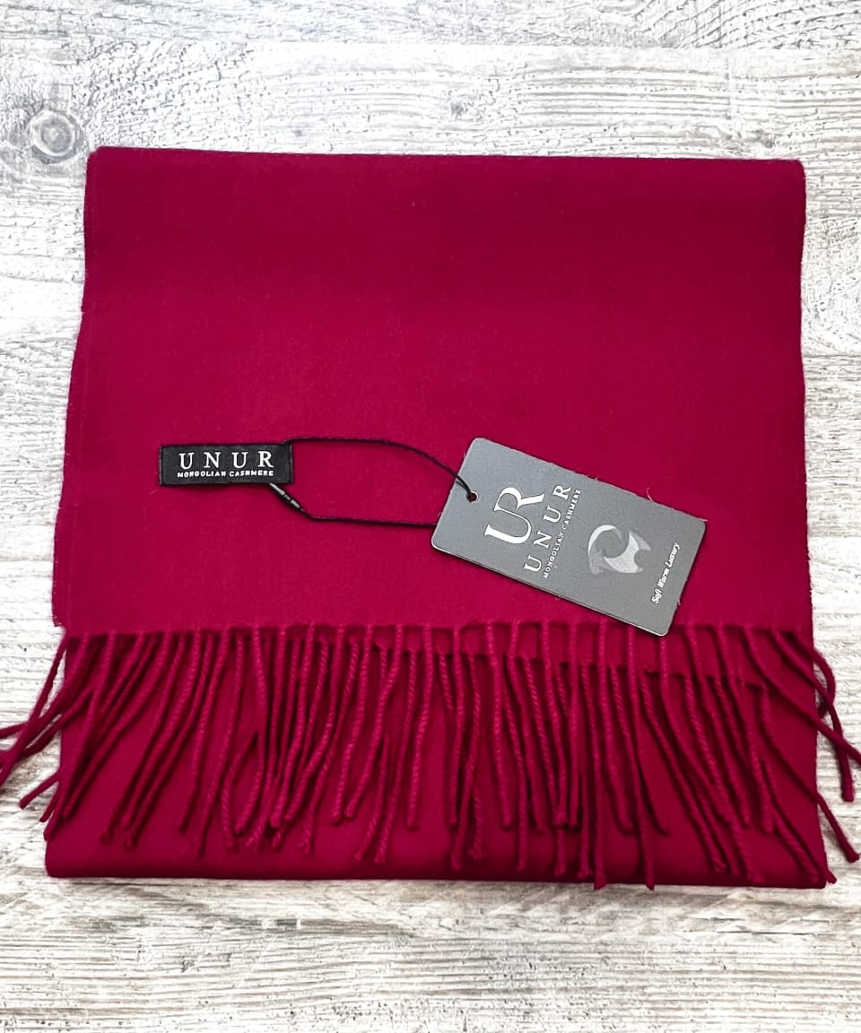 Lay-flat close up of burgundy unisex woven cashmere scarf with tassles