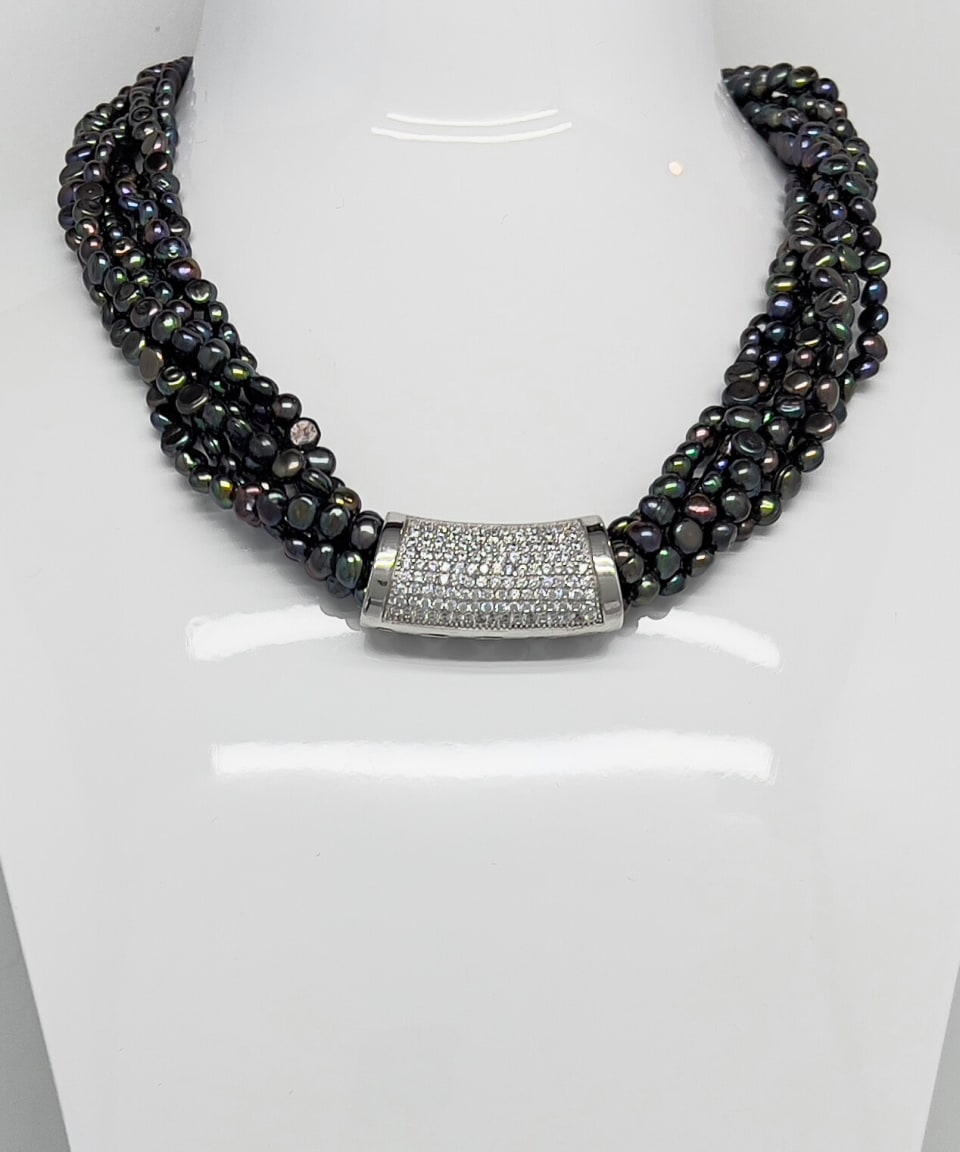 Classic statement necklace with twisted threads of dark baroque pearls and a crystal clasp