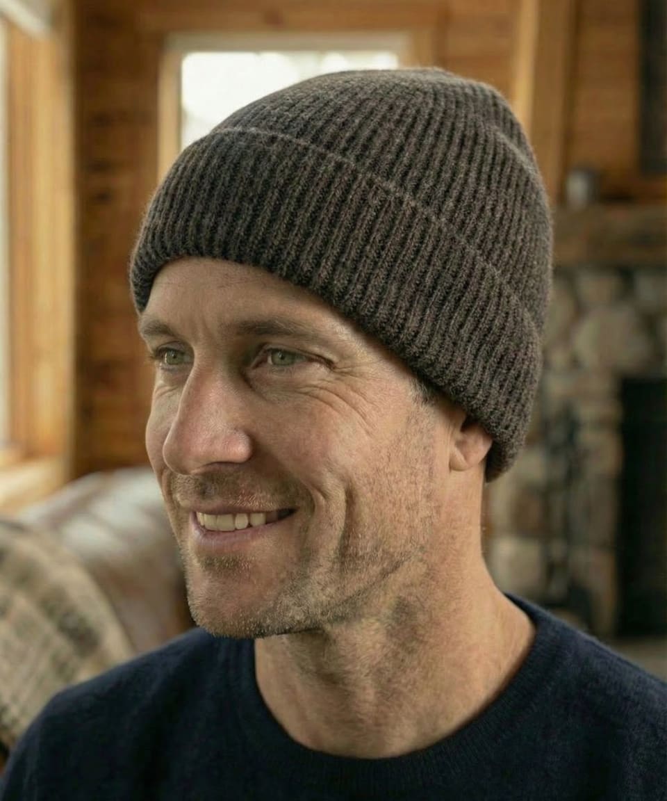 Front head shot view of man indoors wearing ribbed yak wool hat in dark brown