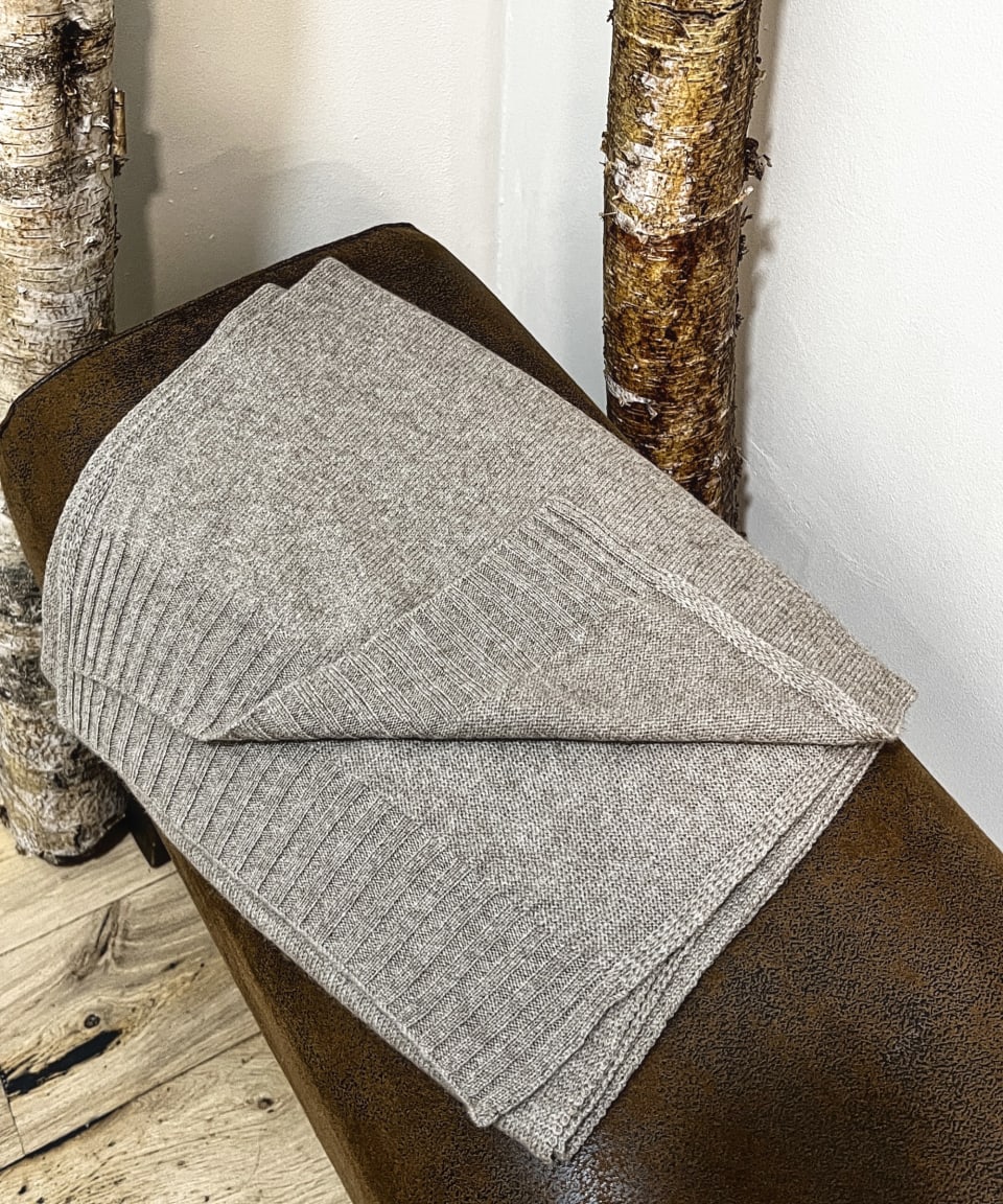 Natural brown cashmere shawl on neutral background, flat view