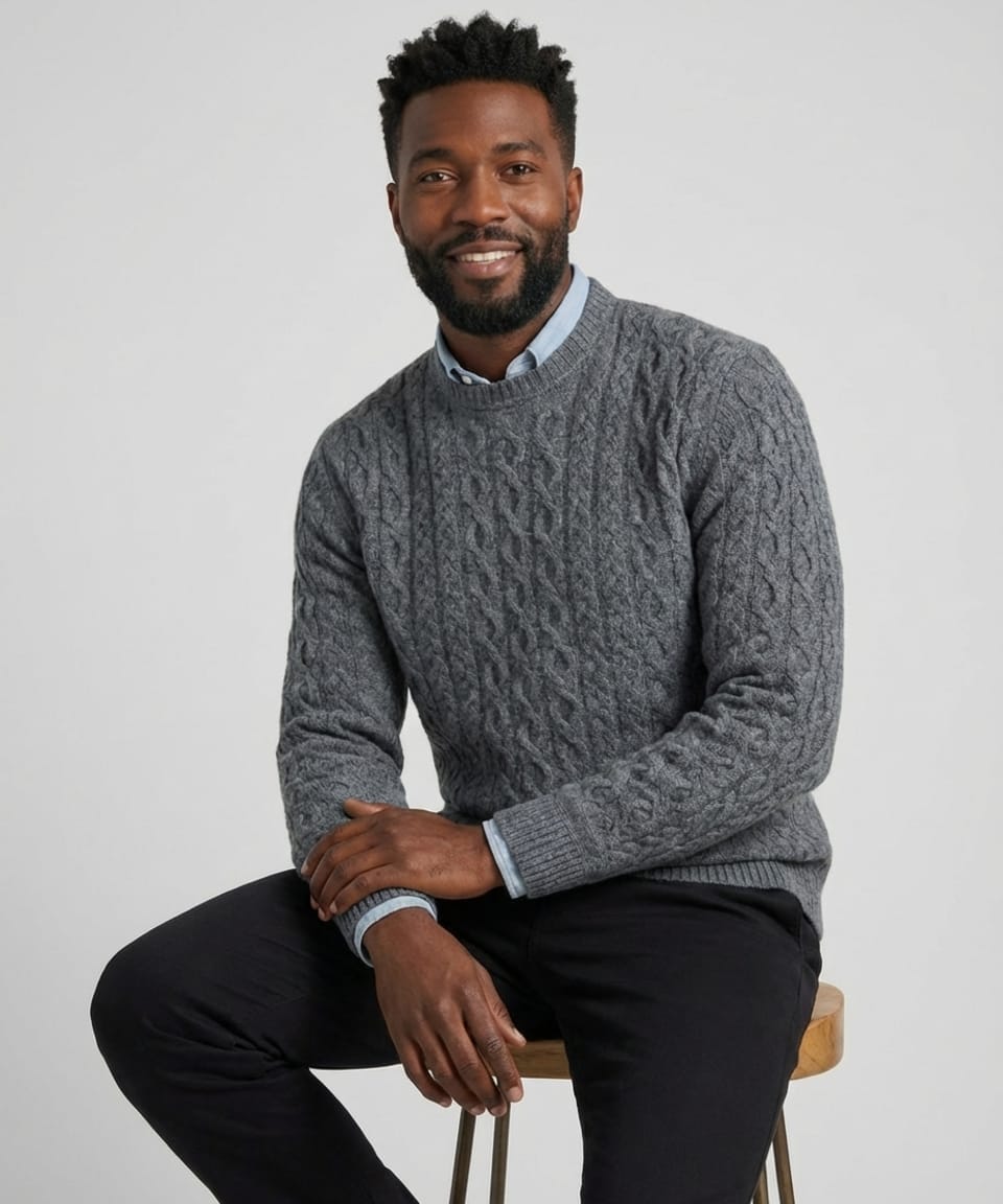 Man wearing a charcoal grey cashmere cable-knit jumper with crew neckline and ribbed trims at collar, cuffs and hem, layered over a light blue shirt – Unur