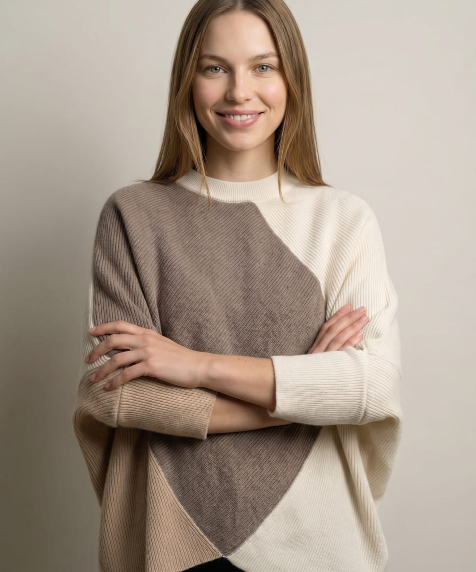Model wearing the oversized three-tone cashmere wrap jumper in mocha brown, cream and camel beige, arms crossed – Unur