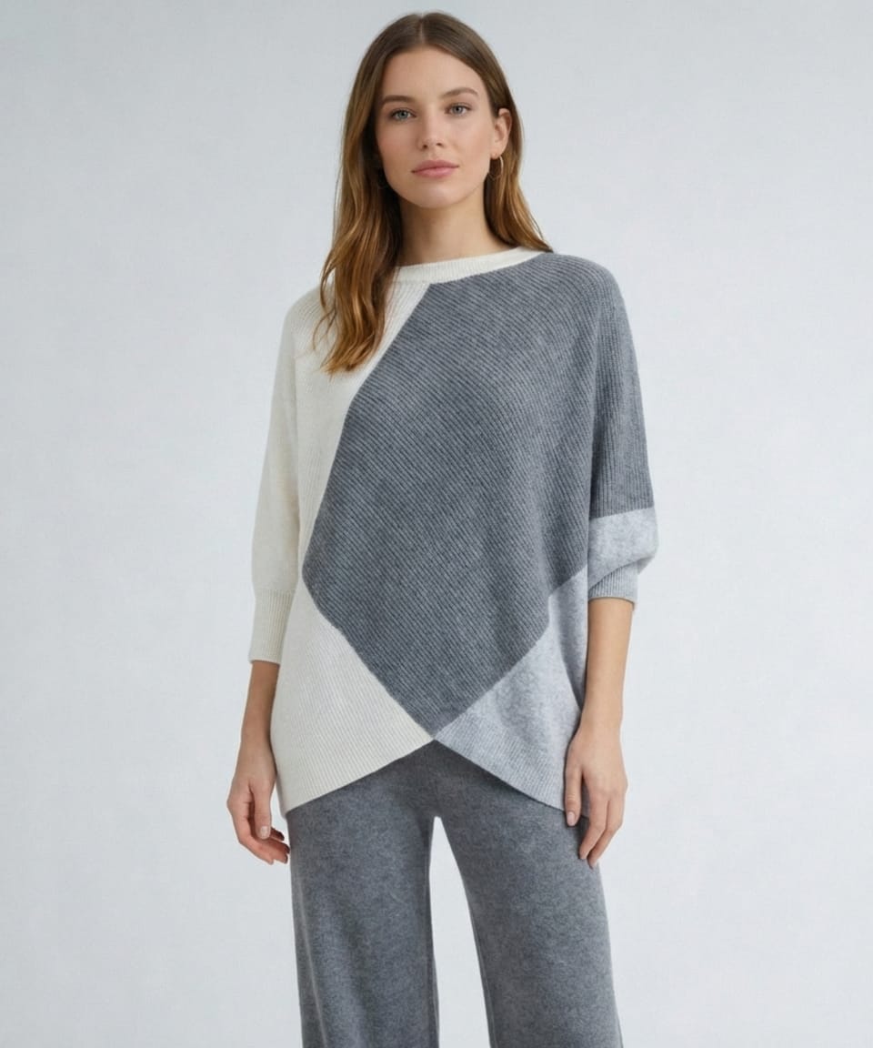 Woman wearing oversized cashmere jumper with cream and grey colour-block panels, vertical rib knit and asymmetrical crossover hem – Unur