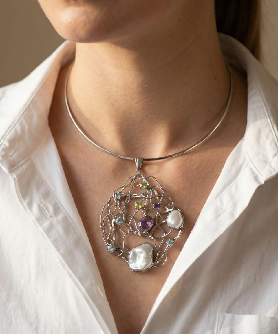 Model wearing the Keshi Pearl & Gem Lattice Pendant Statement Collar over a white shirt.