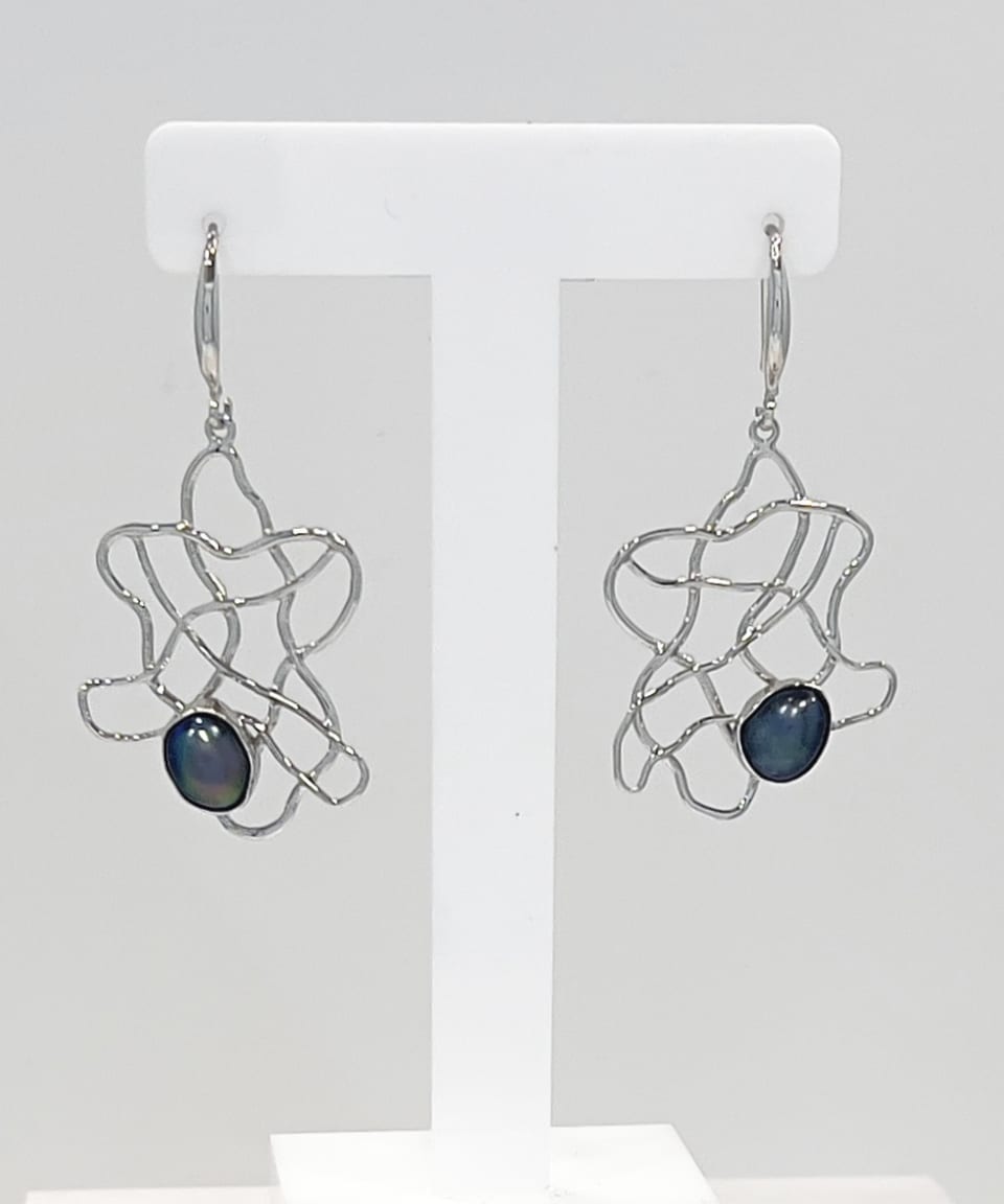 Keshi pearls nestled within a flowing silver wave lattice design