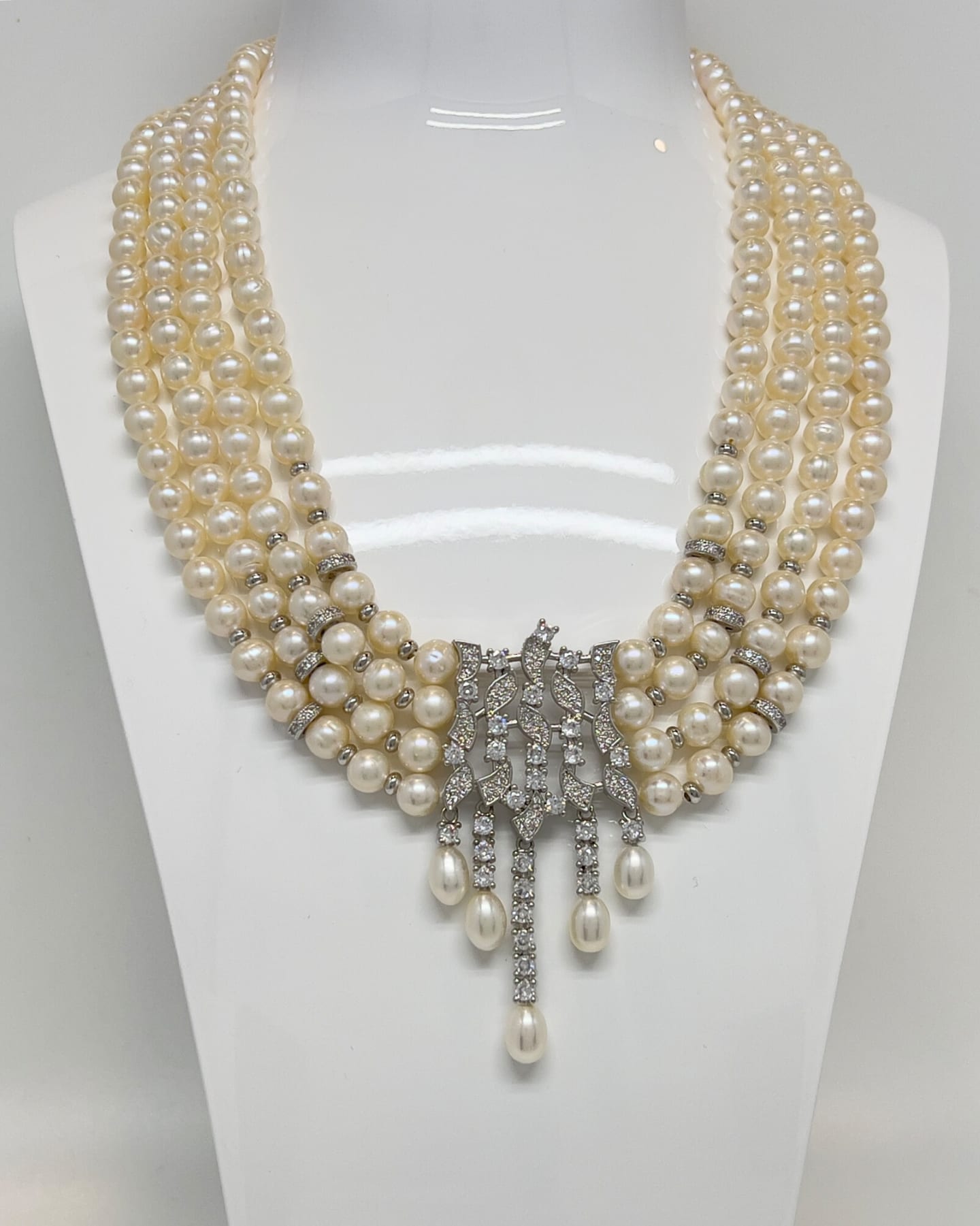 Classic four-strand layered pearl necklace with crystal pendants