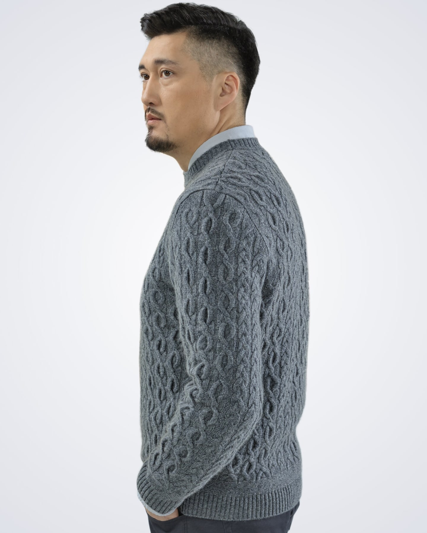 Man wearing a cashmere cable jumper in grey, side view
