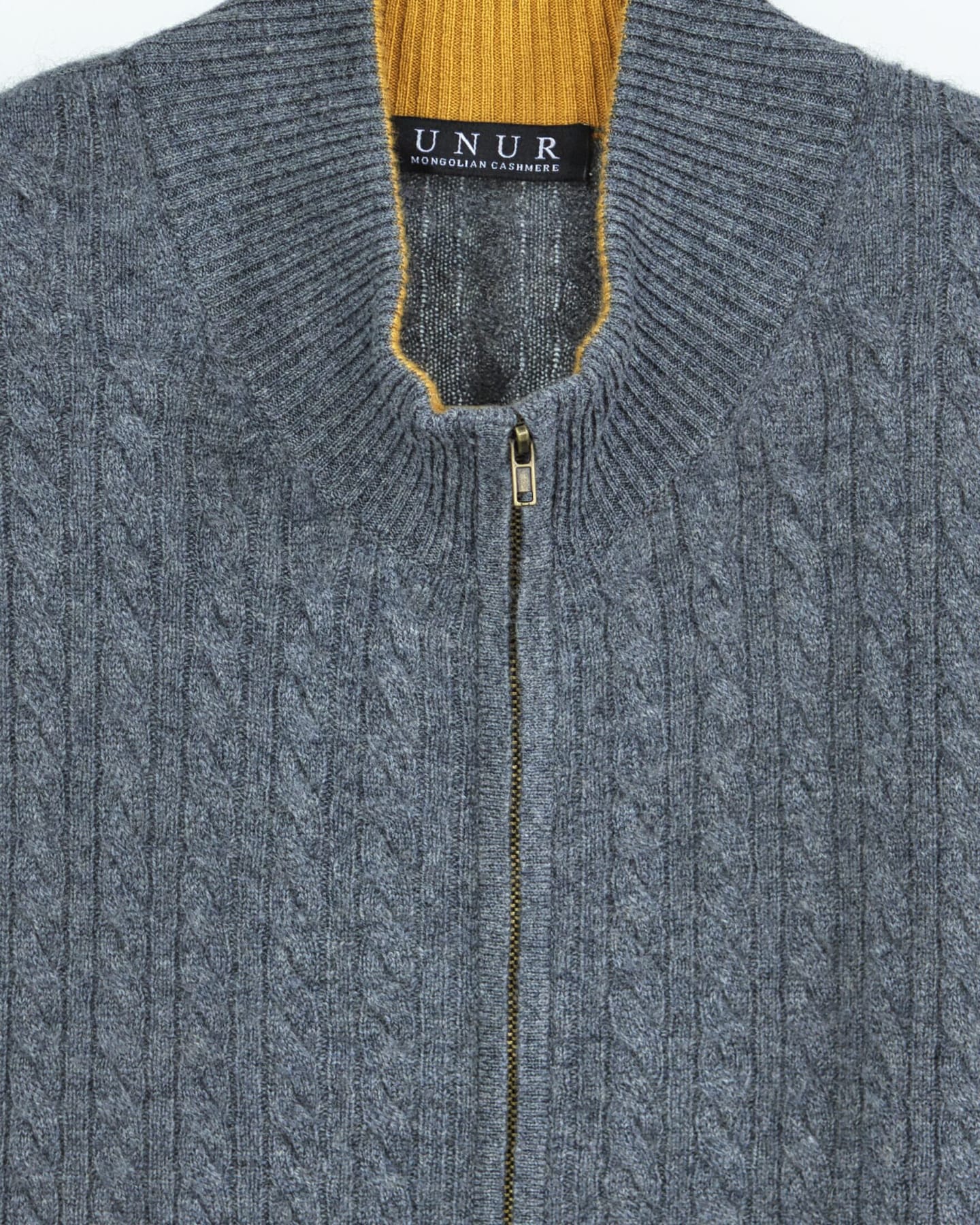 Close up of a luxury cashmere cable knit cardigan in grey
