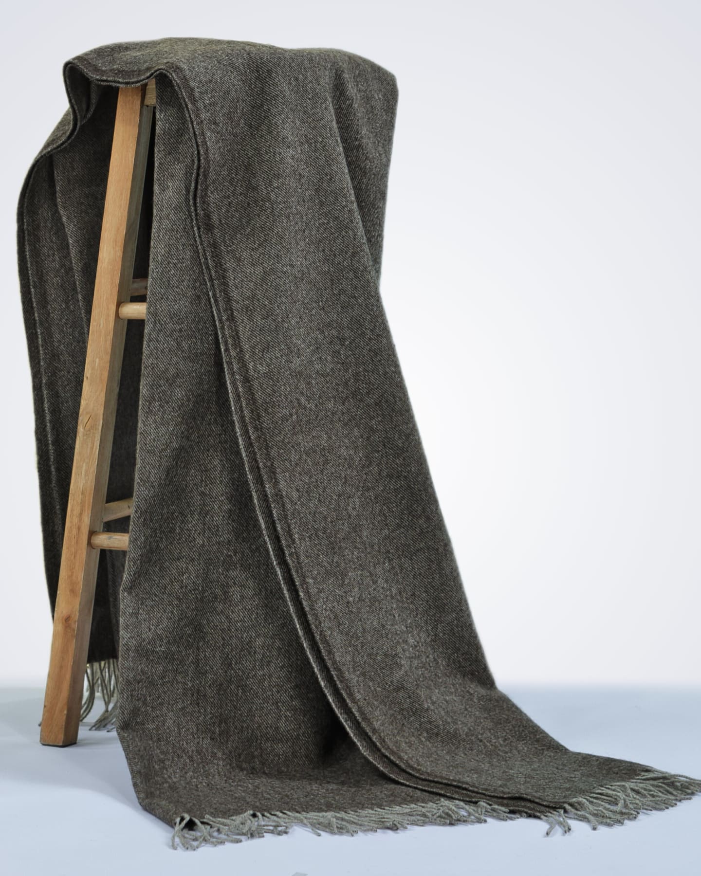 natural dark brown yak wool blanket draped over a chair