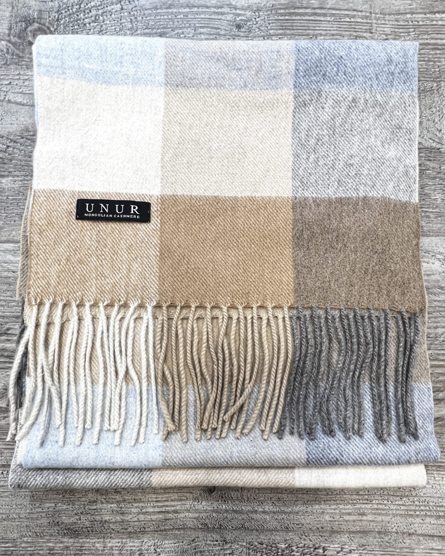 Lay-flat close up of check brown unisex woven cashmere scarf with tassles
