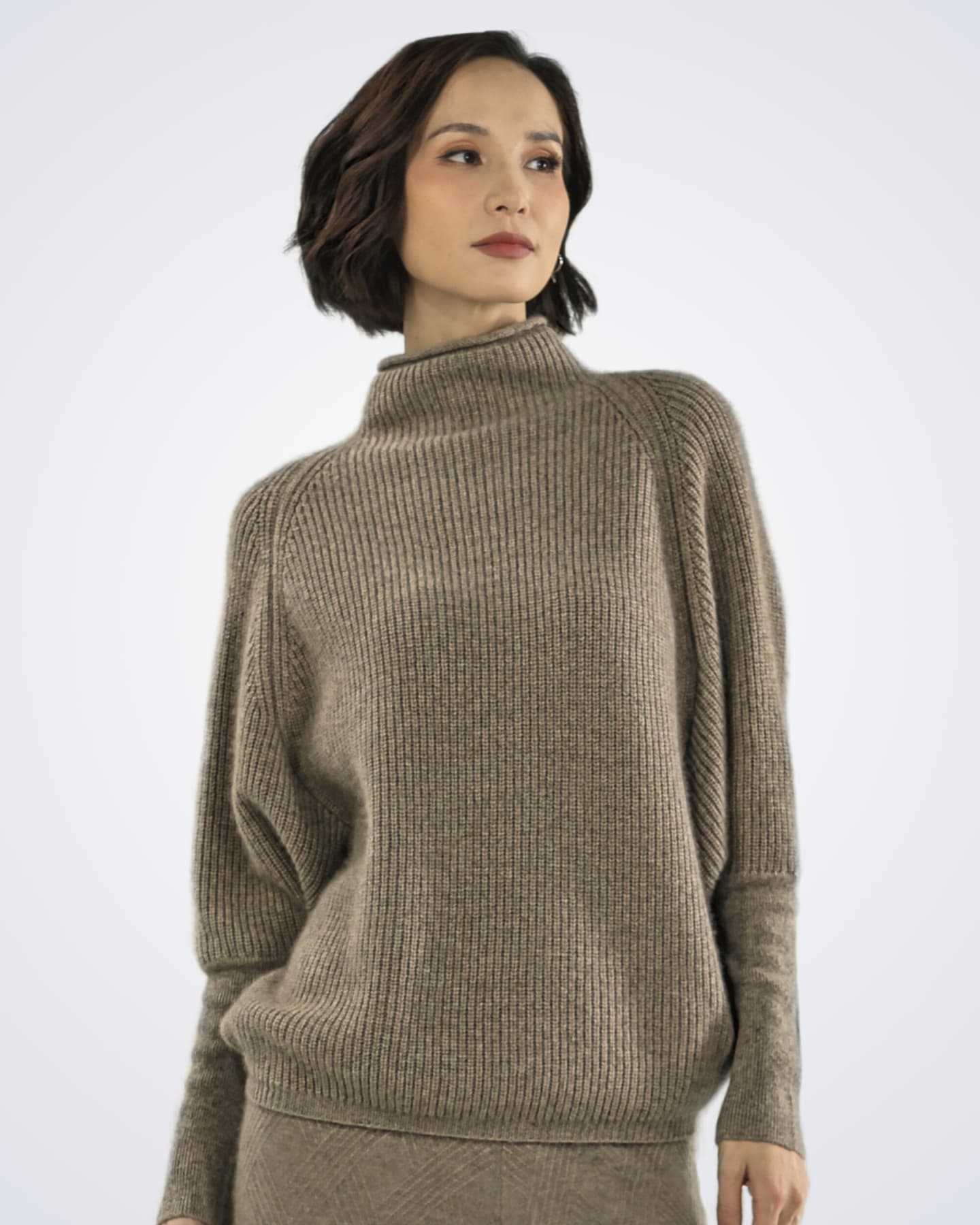 Front detail of natural brown cashmere jumper showing ribbed texture and high neckline