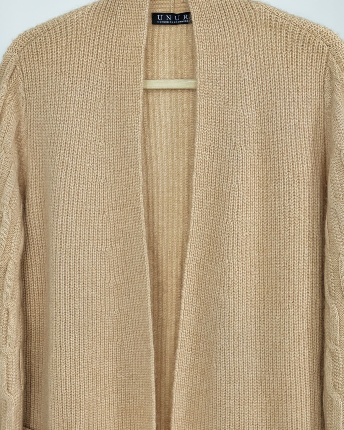 Close-up of soft cashmere ribbed cardigan in natural beige