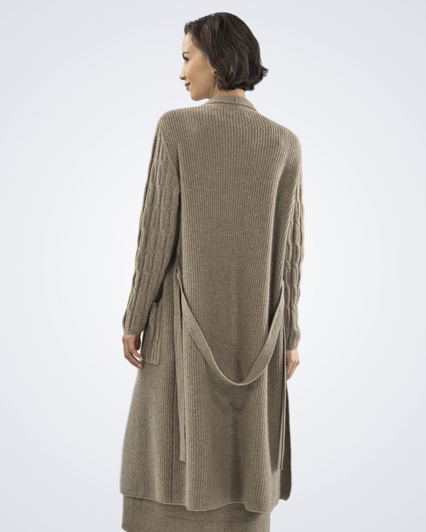 Back view of model wearing soft cashmere ribbed cardigan in natural brown