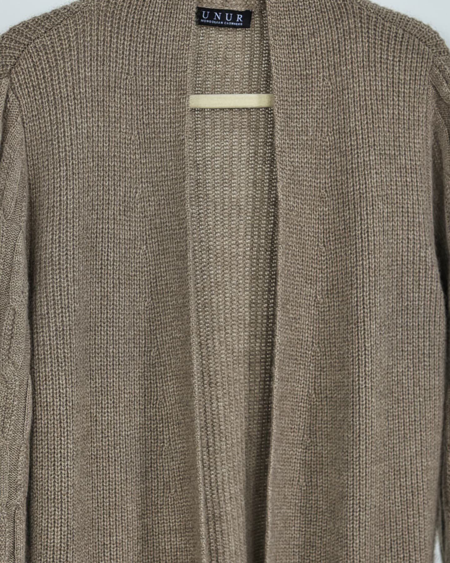 Close-up of soft cashmere ribbed cardigan in natural brown