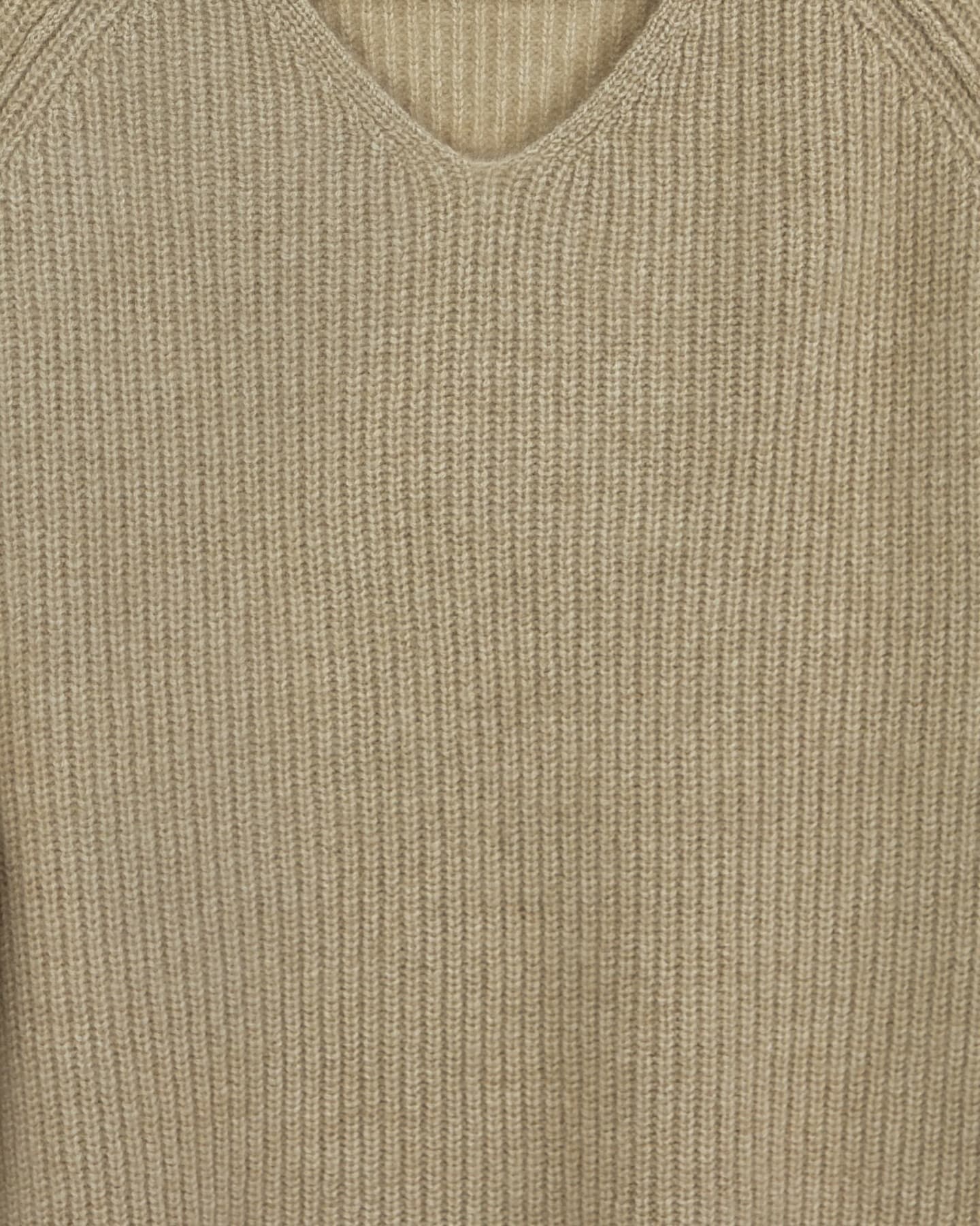 Close-up of soft cashmere ribbed jumper in natural beige