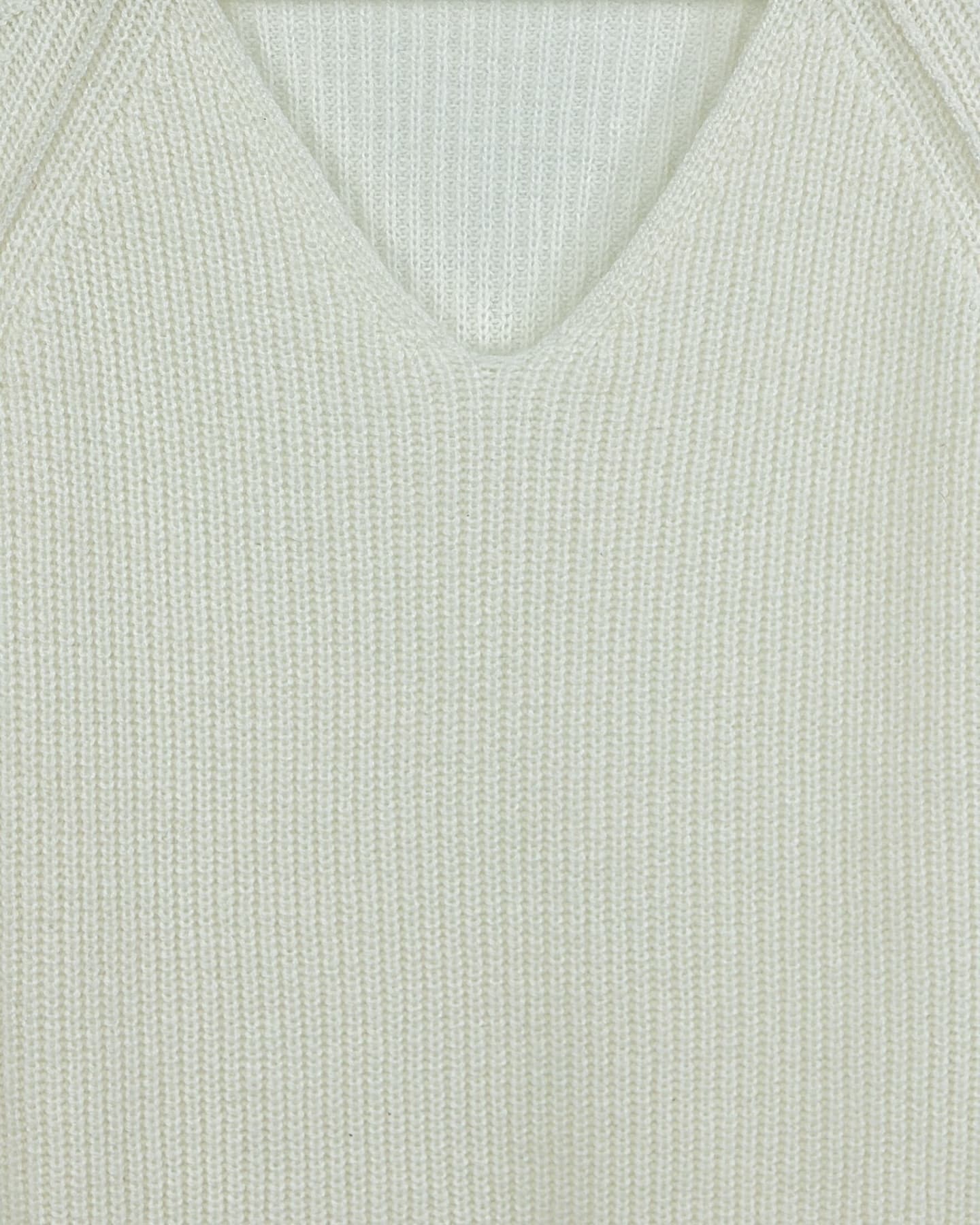 Close-up of soft cashmere ribbed jumper in white