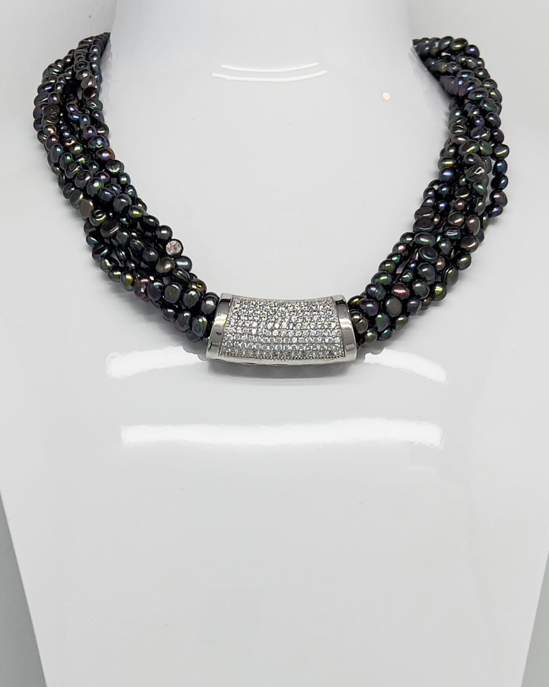Classic statement necklace with twisted threads of dark baroque pearls and a crystal clasp