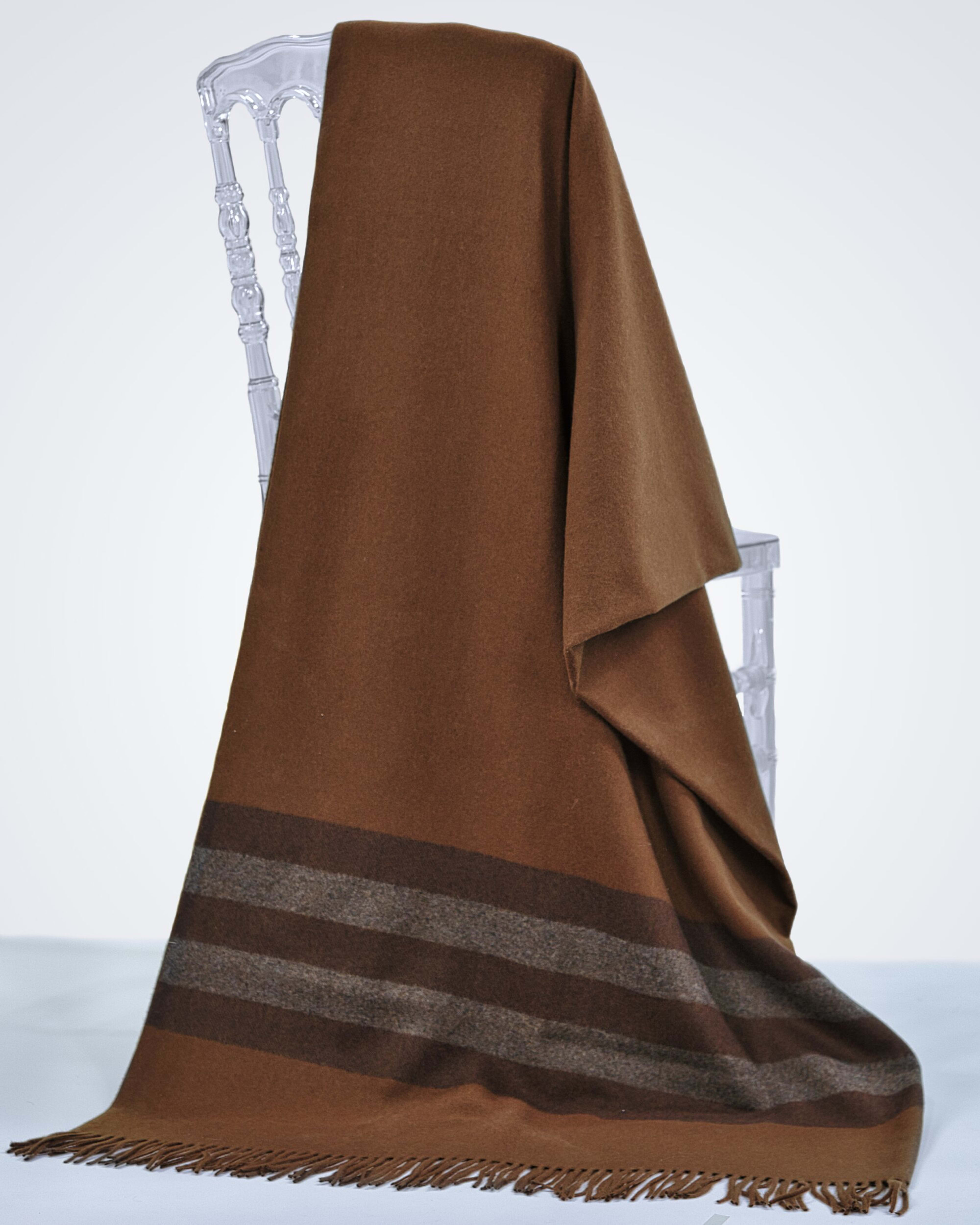 brown cashmere blanket draped over a chair