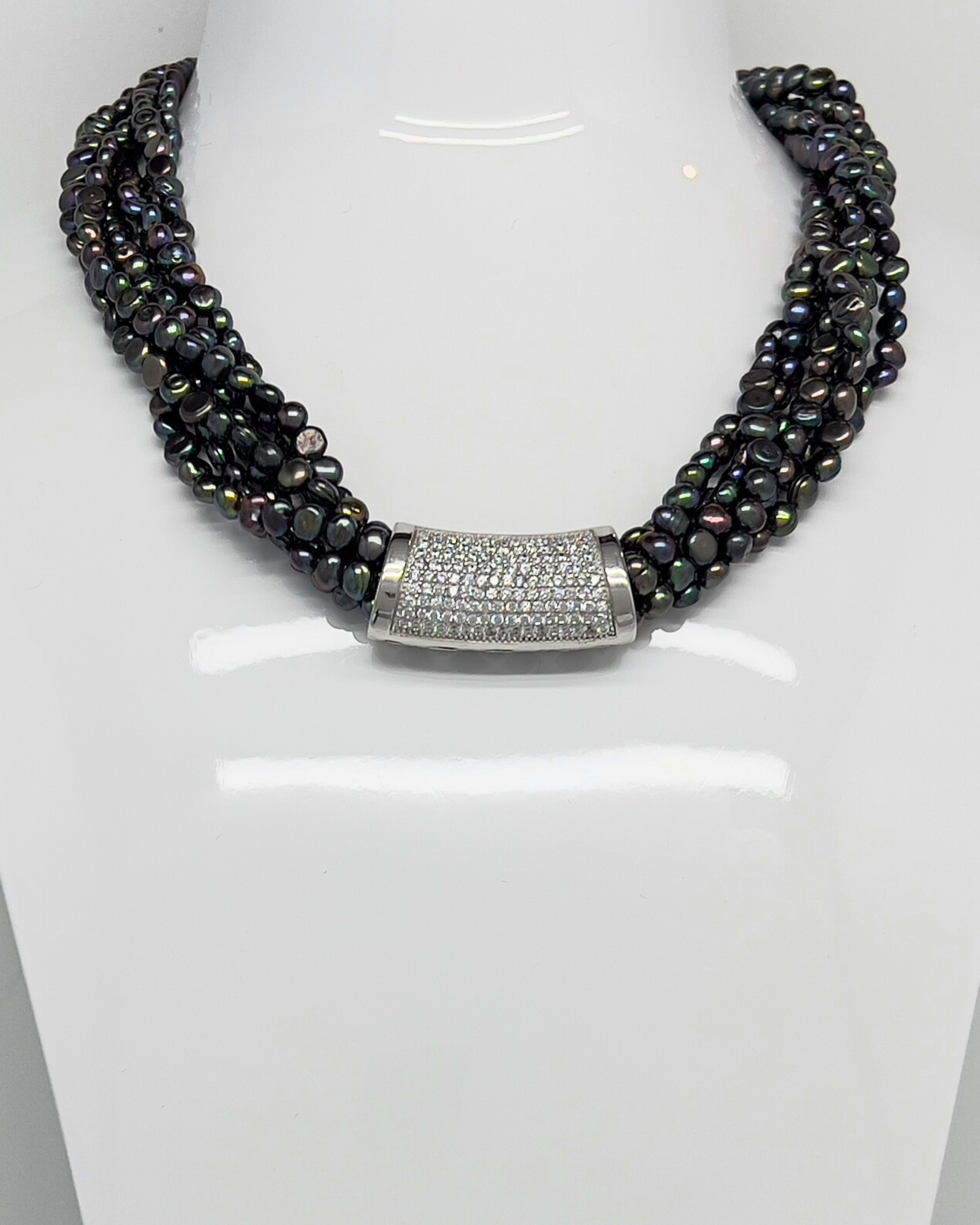 Classic statement necklace with twisted threads of dark baroque pearls and a crystal clasp