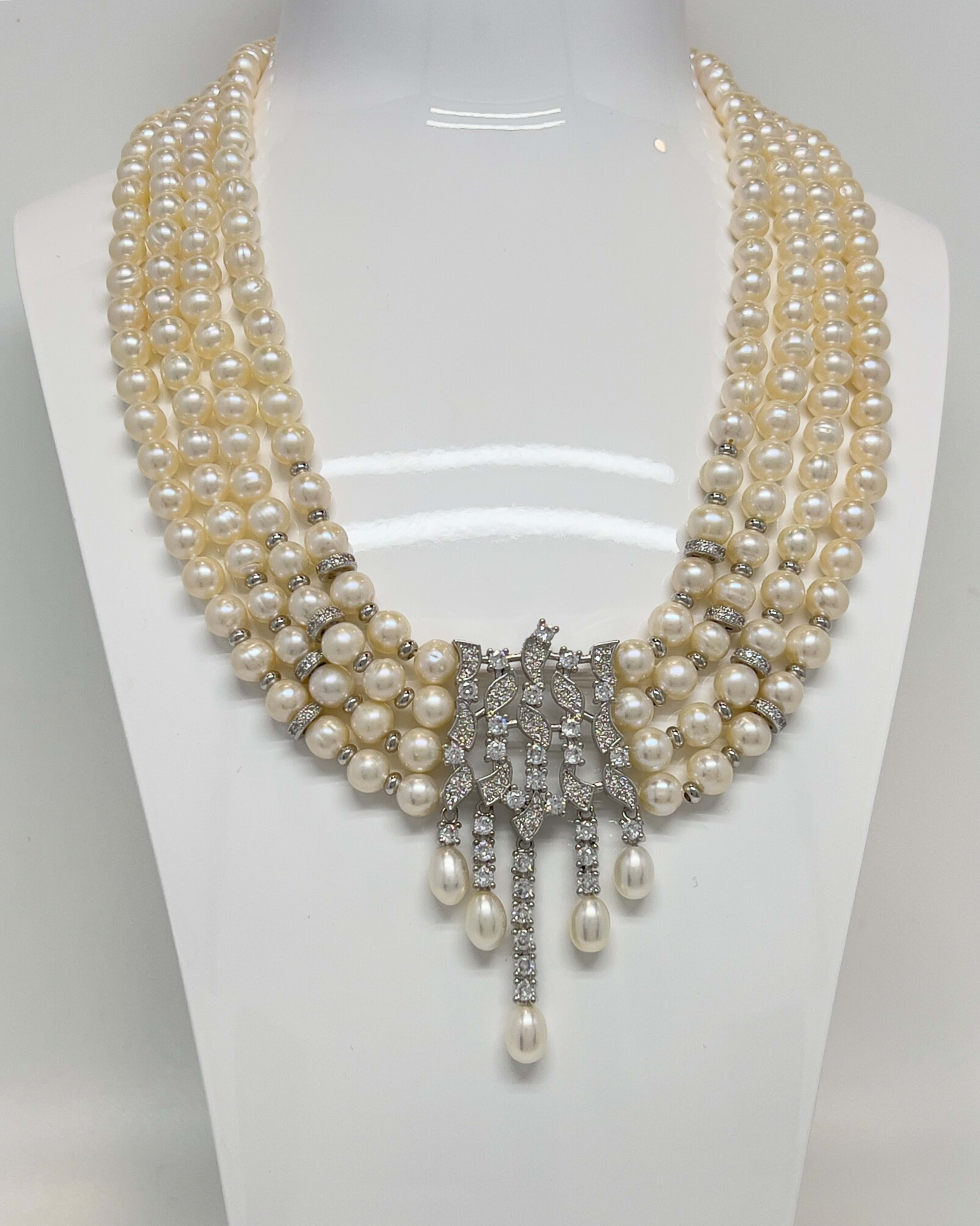 Classic four-strand layered pearl necklace with crystal pendants