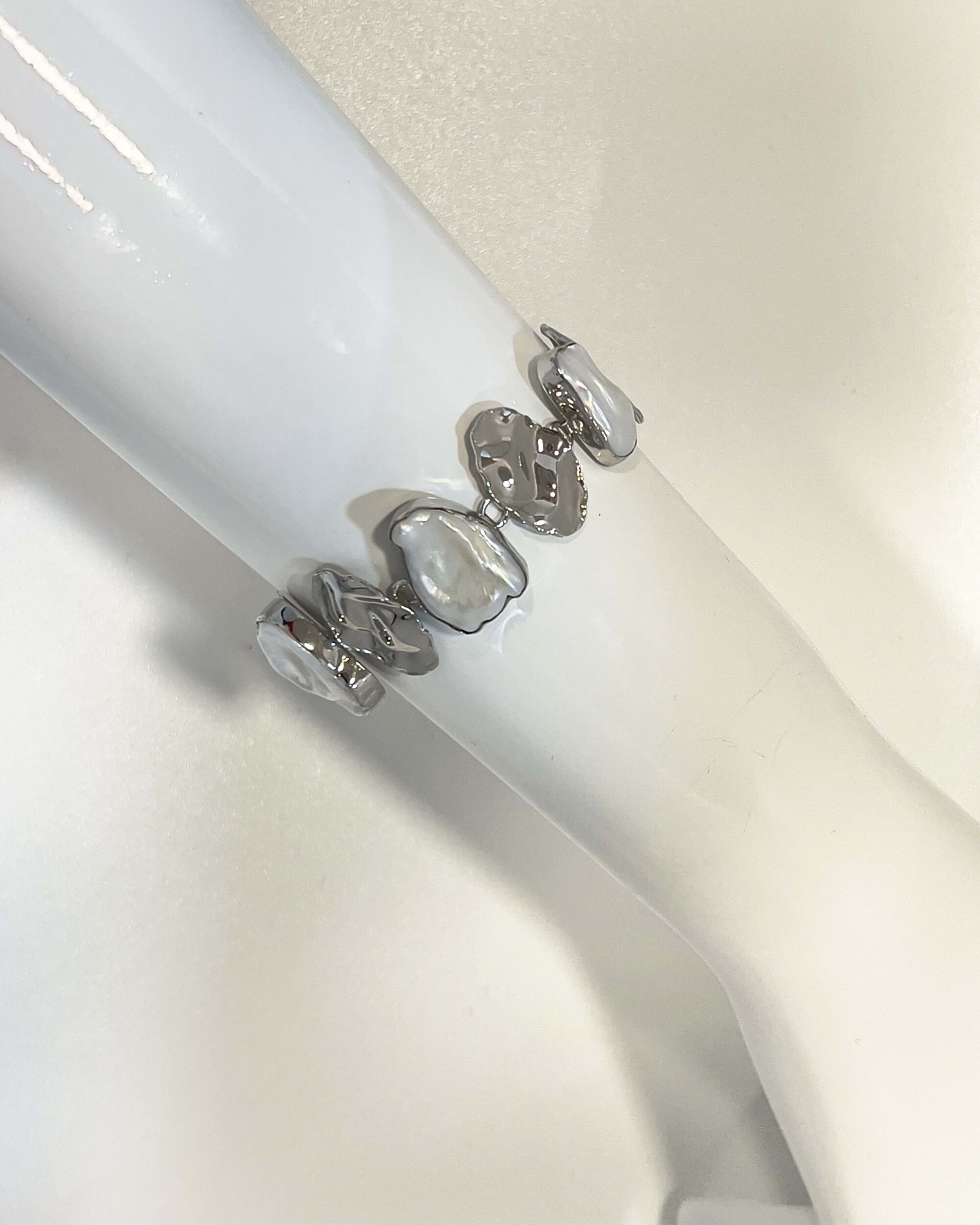 Model wearing signature keshi pearl statement chain bracelet with silver leaves