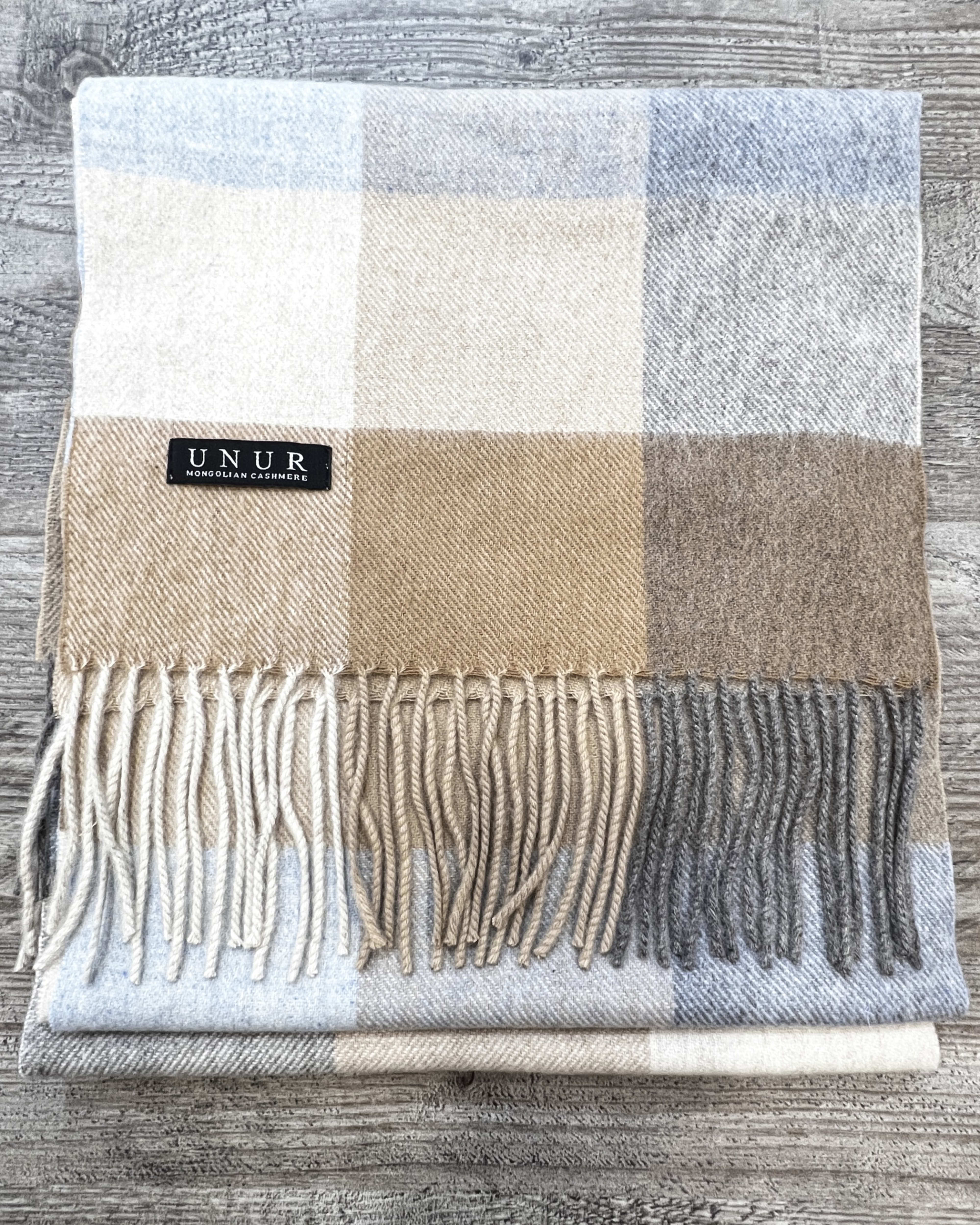 Lay-flat close up of check brown unisex woven cashmere scarf with tassles