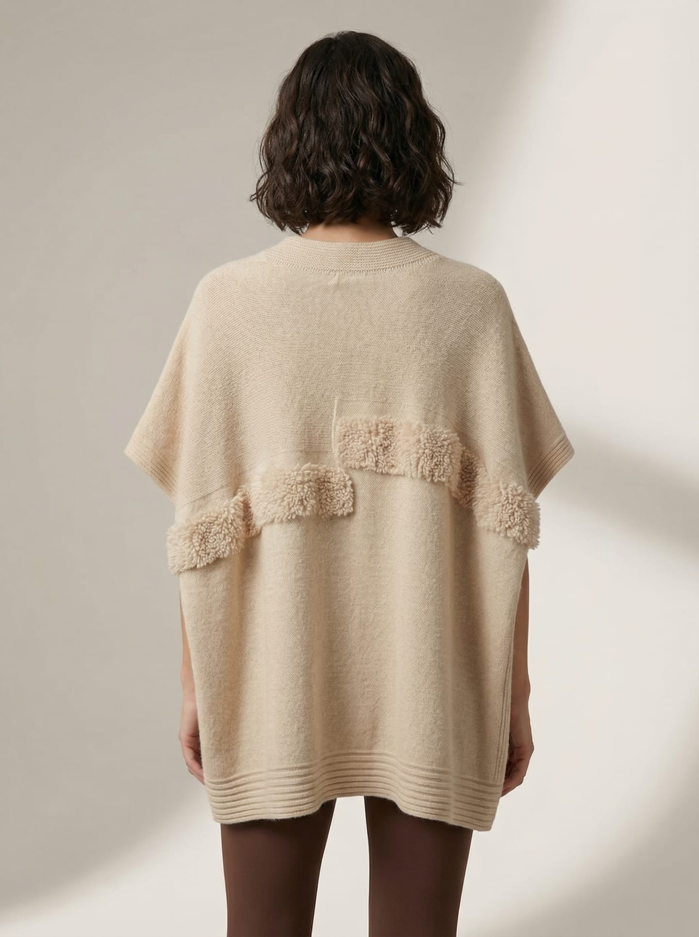 Back view of natural beige cashmere cape top showing horizontal boucle panel