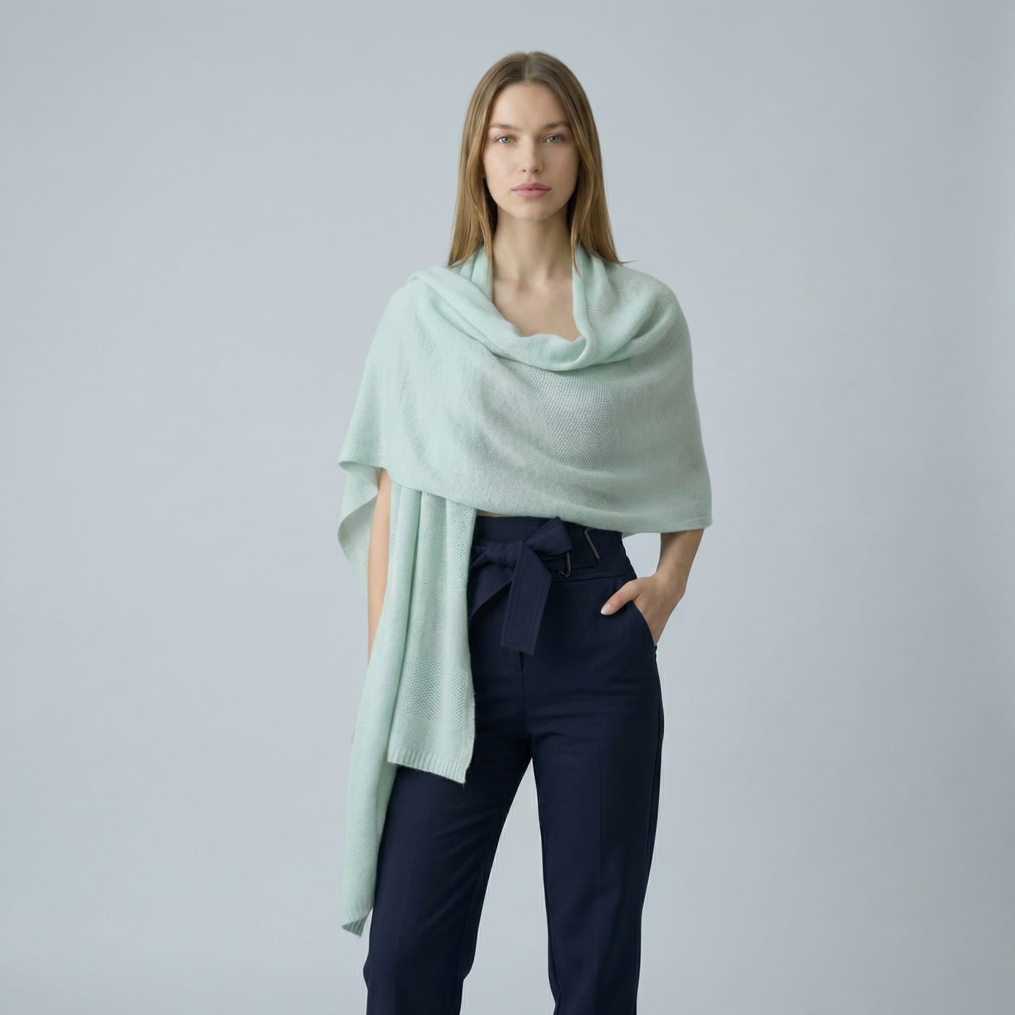 Woman wrapped in a lightweight knitted cashmere shawl in mint green