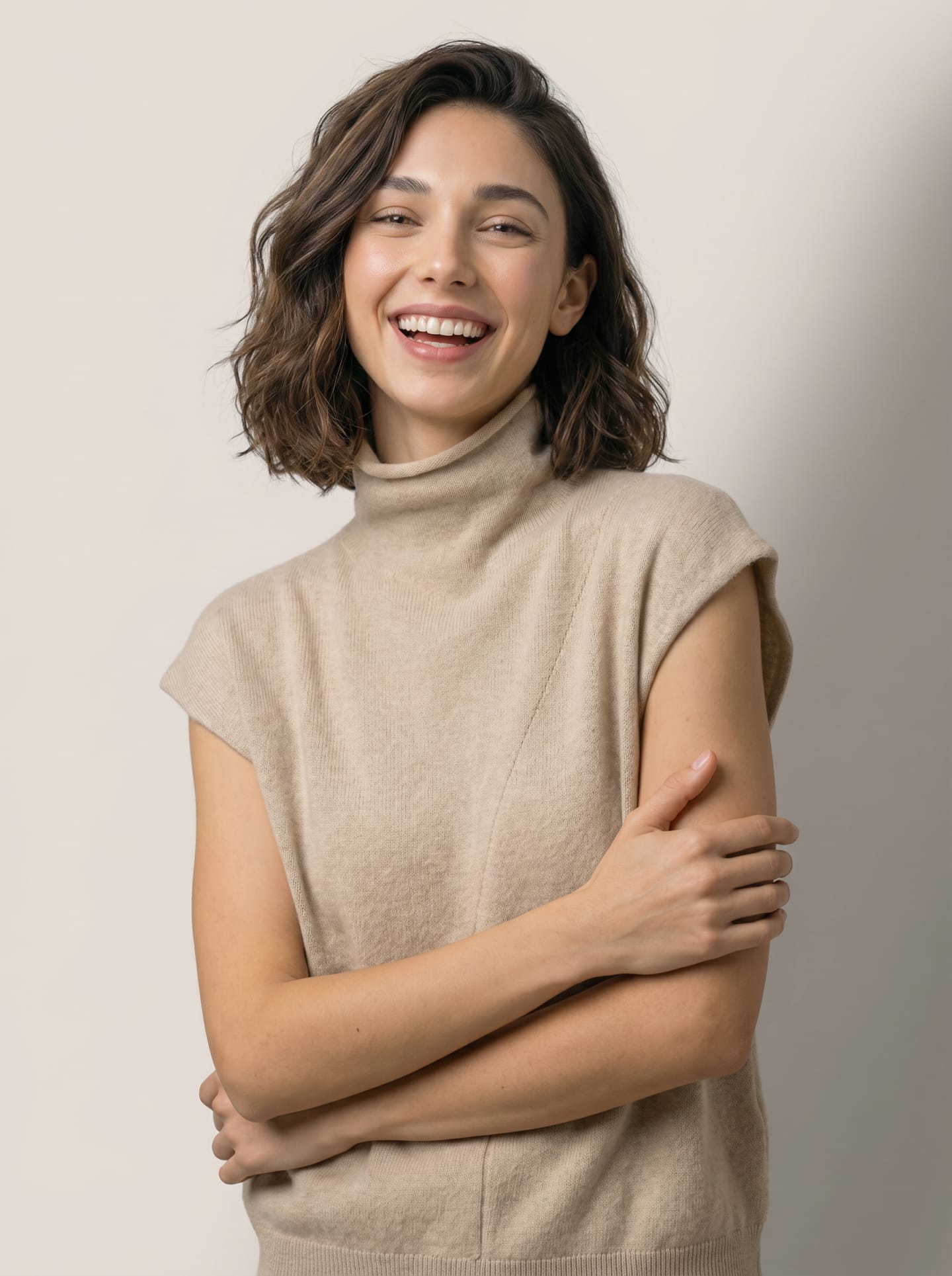 Model wearing the women's high neck cashmere vest in natural beige, three-quarter view with the front panel seam visible – Unur