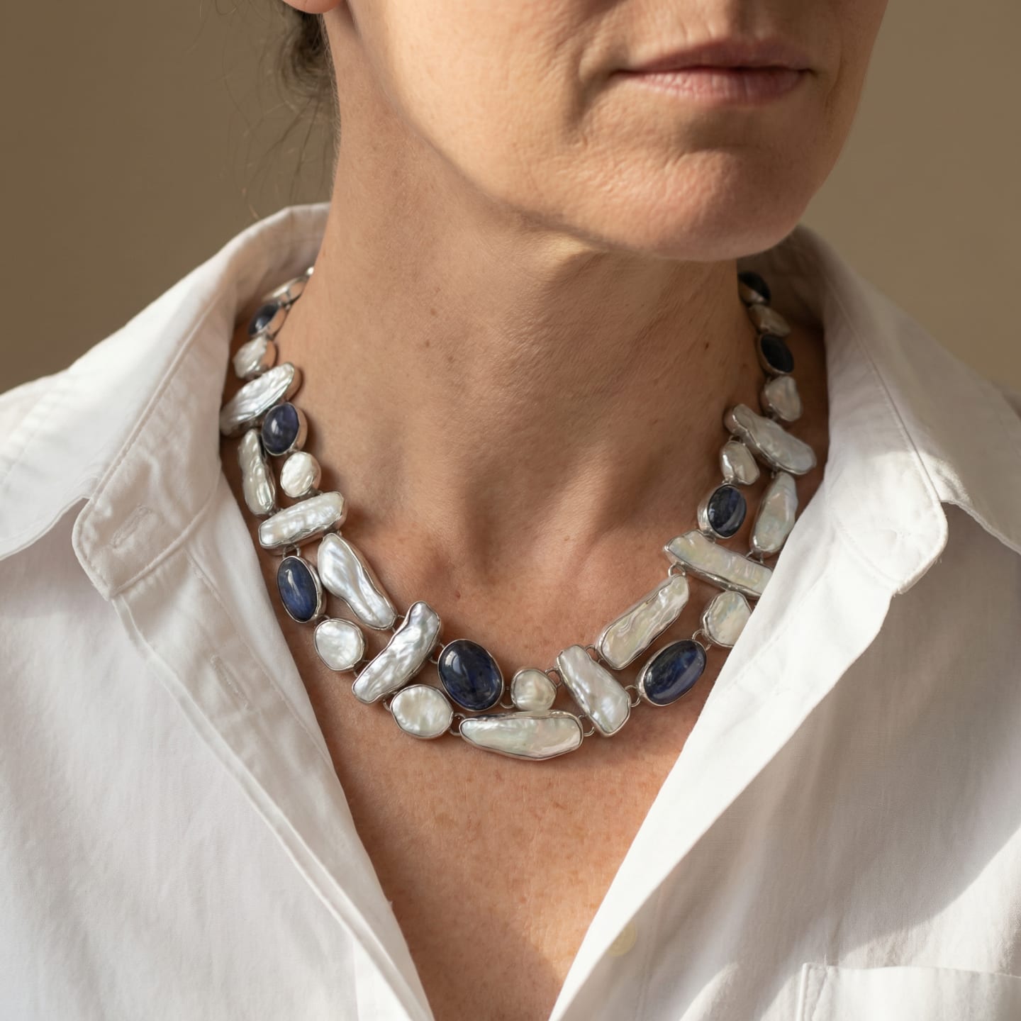 Detail of the Signature Biwa Pearl and Kyanite necklace showing the double-strand bib construction, individually bezel-set Biwa pearls and oval kyanite stones linked together in polished sterling silver