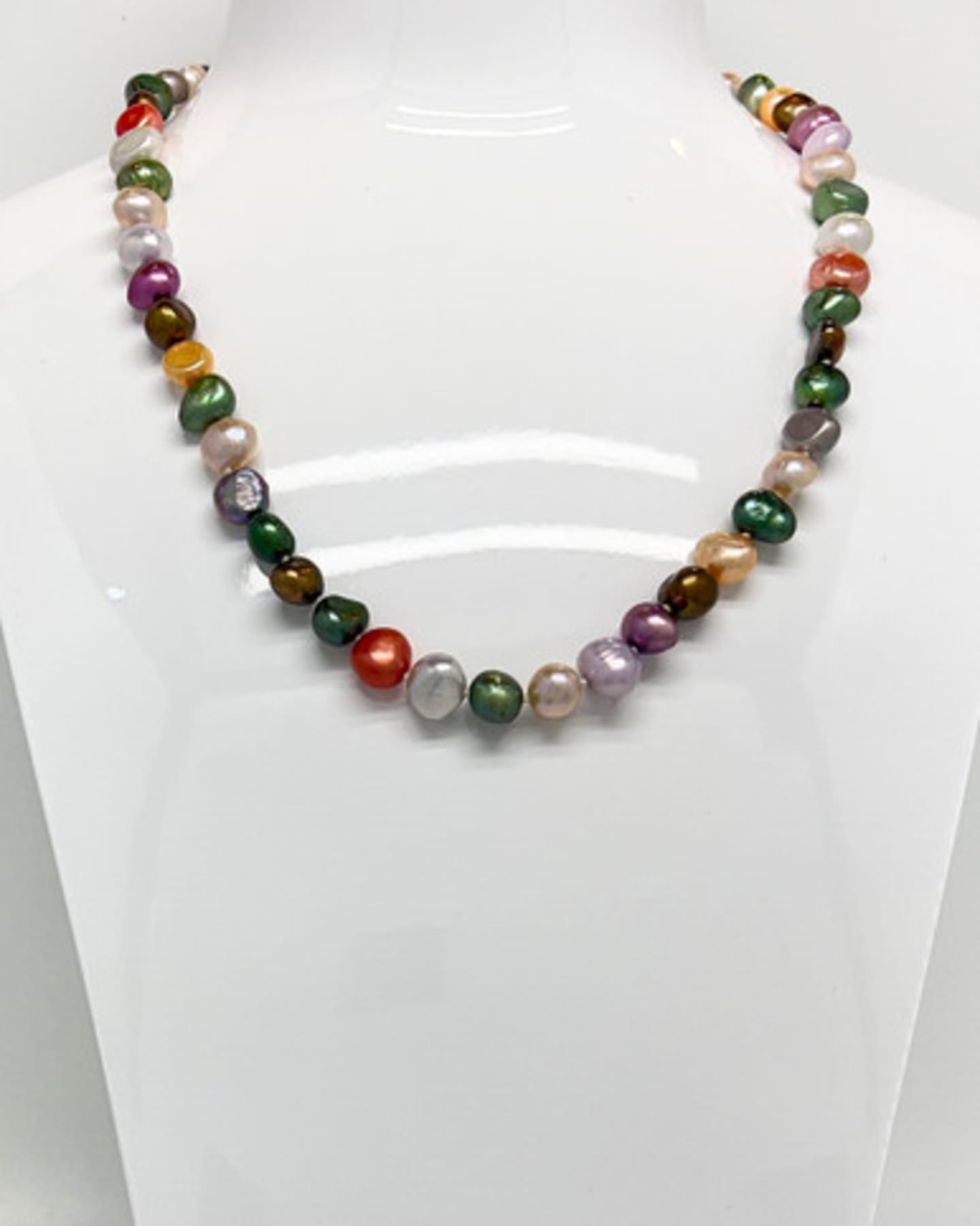 Unur classic multi-coloured baroque pearl necklace displayed on a white necklace stand, showing the collar-length silhouette and natural iridescence of the freshwater pearls