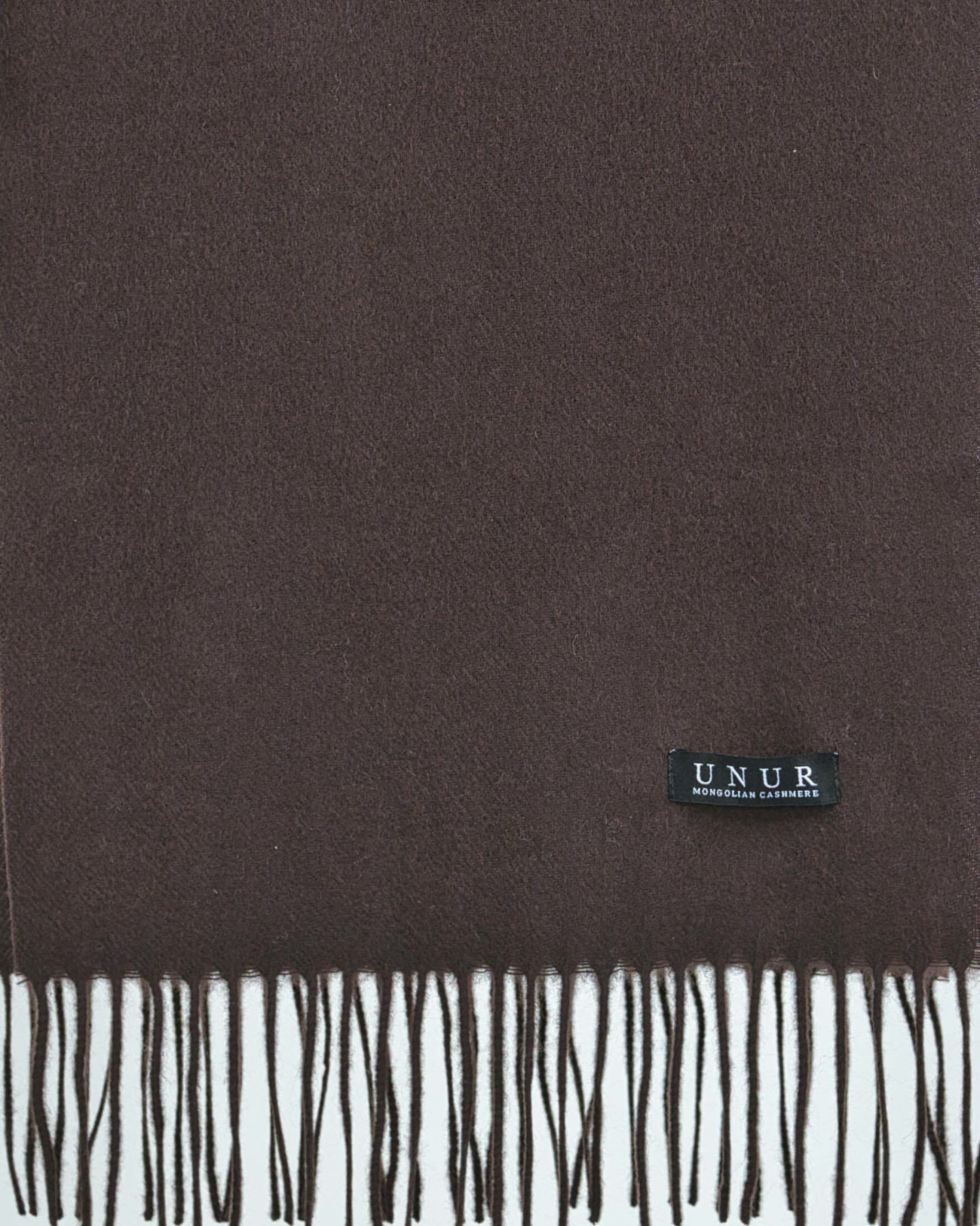 Closeup of a chocolate brown unisex cashmere scarf showing weave texture