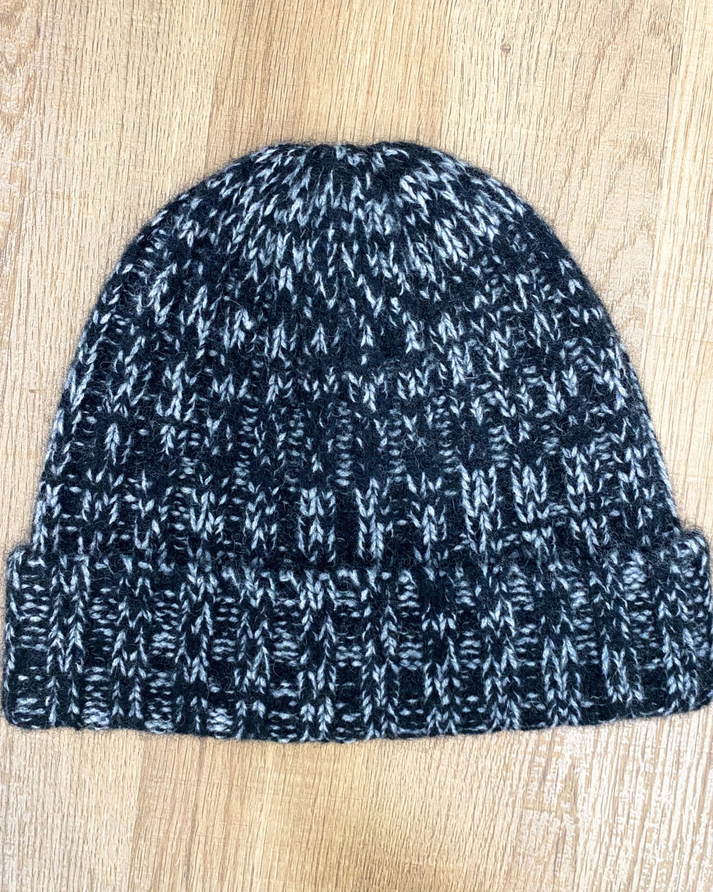 Lay flat picture of chunky ribbed yak wool hat in mottled black & white