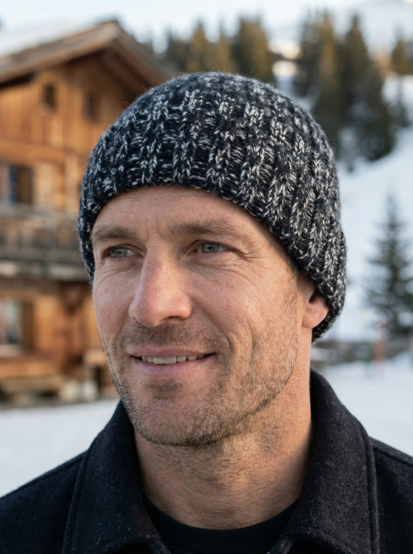 Front view of man outdoors wearing chunky ribbed yak wool hat in mottled black & white