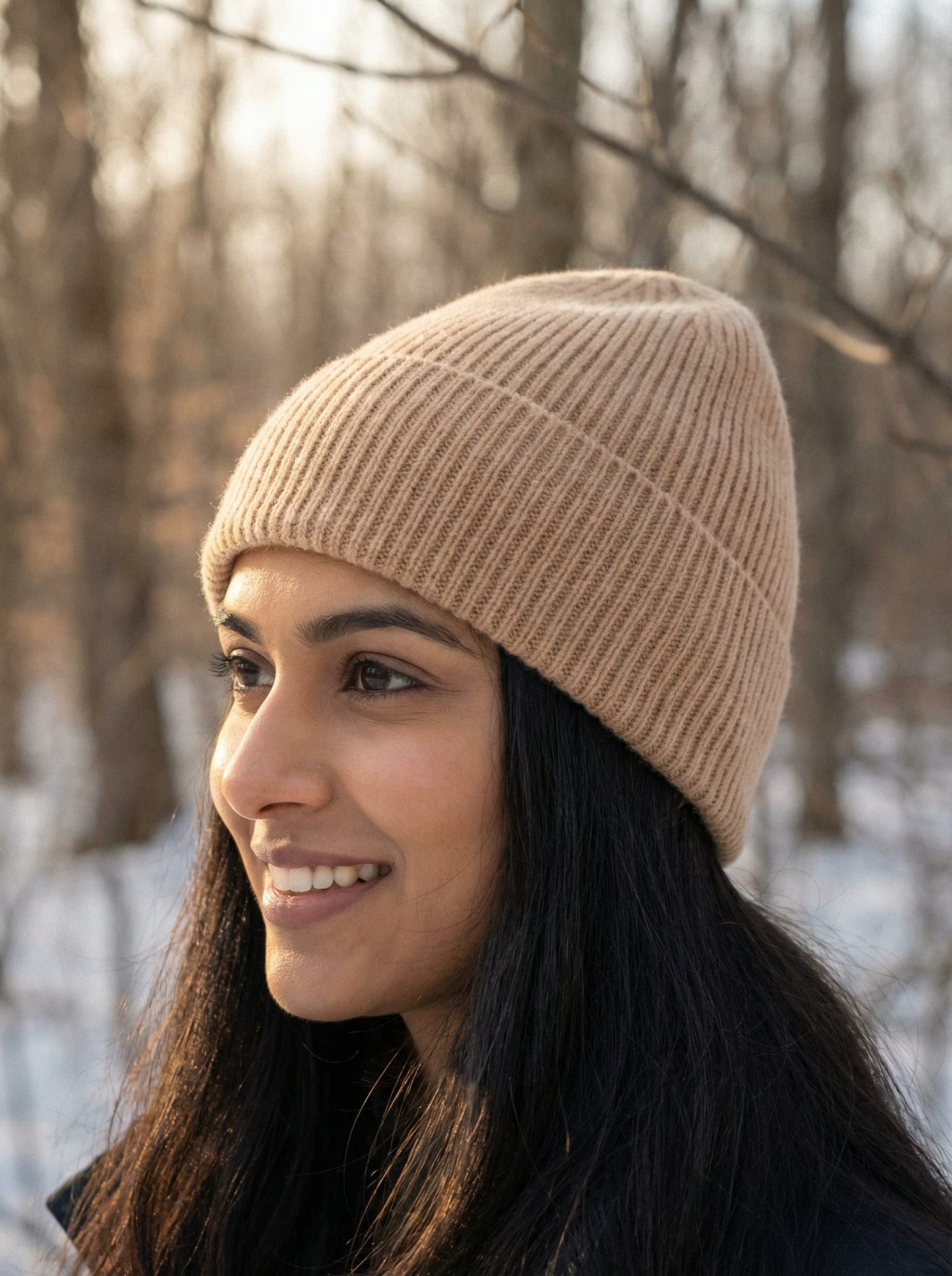 Woman wearing camel beige ribbed cashmere hat outdoors, front view