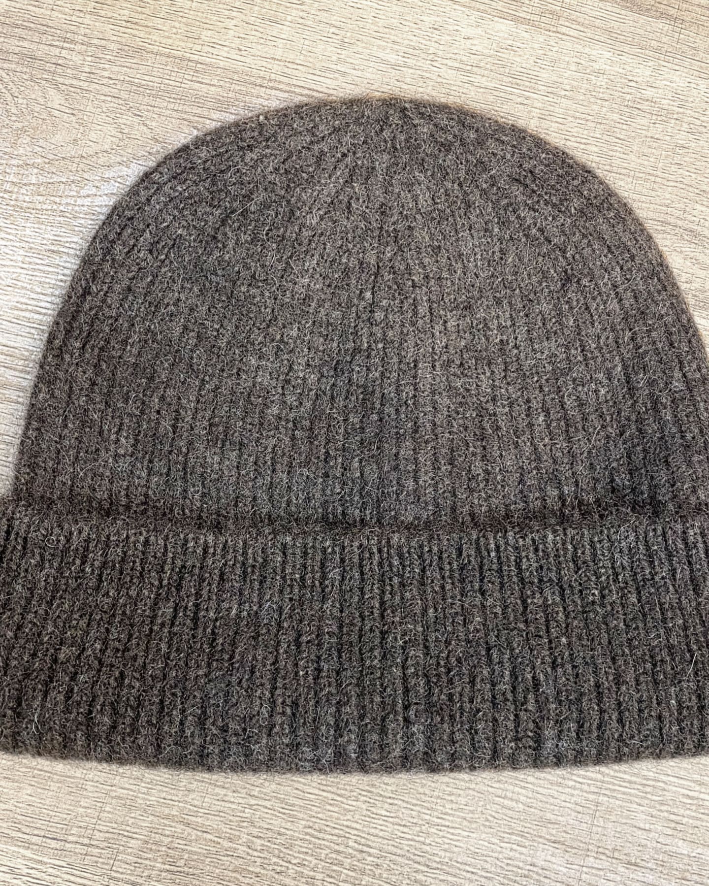 Lay-flat view of ribbed yak wool hat in dark brown