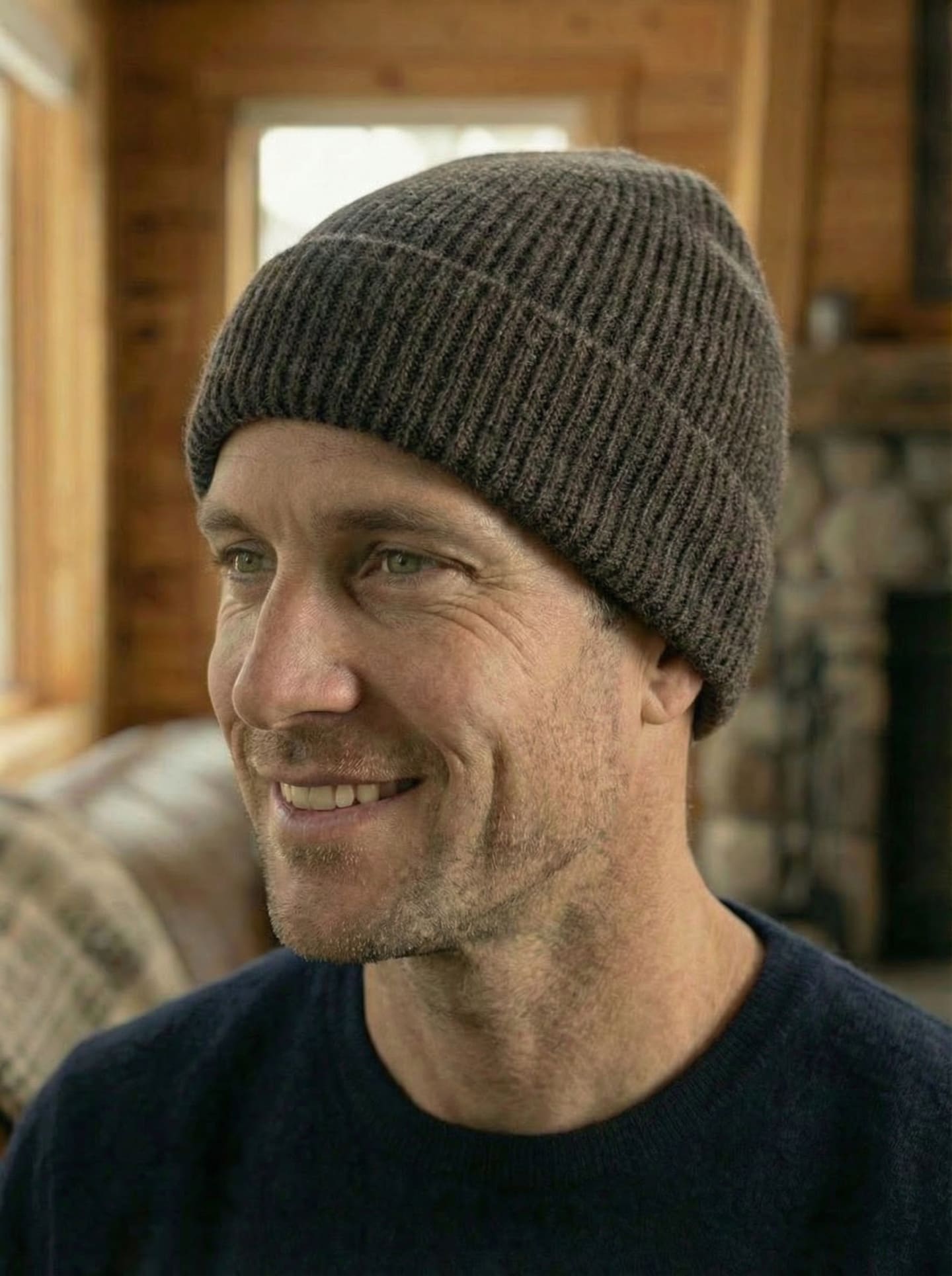 Front head shot view of man indoors wearing ribbed yak wool hat in dark brown