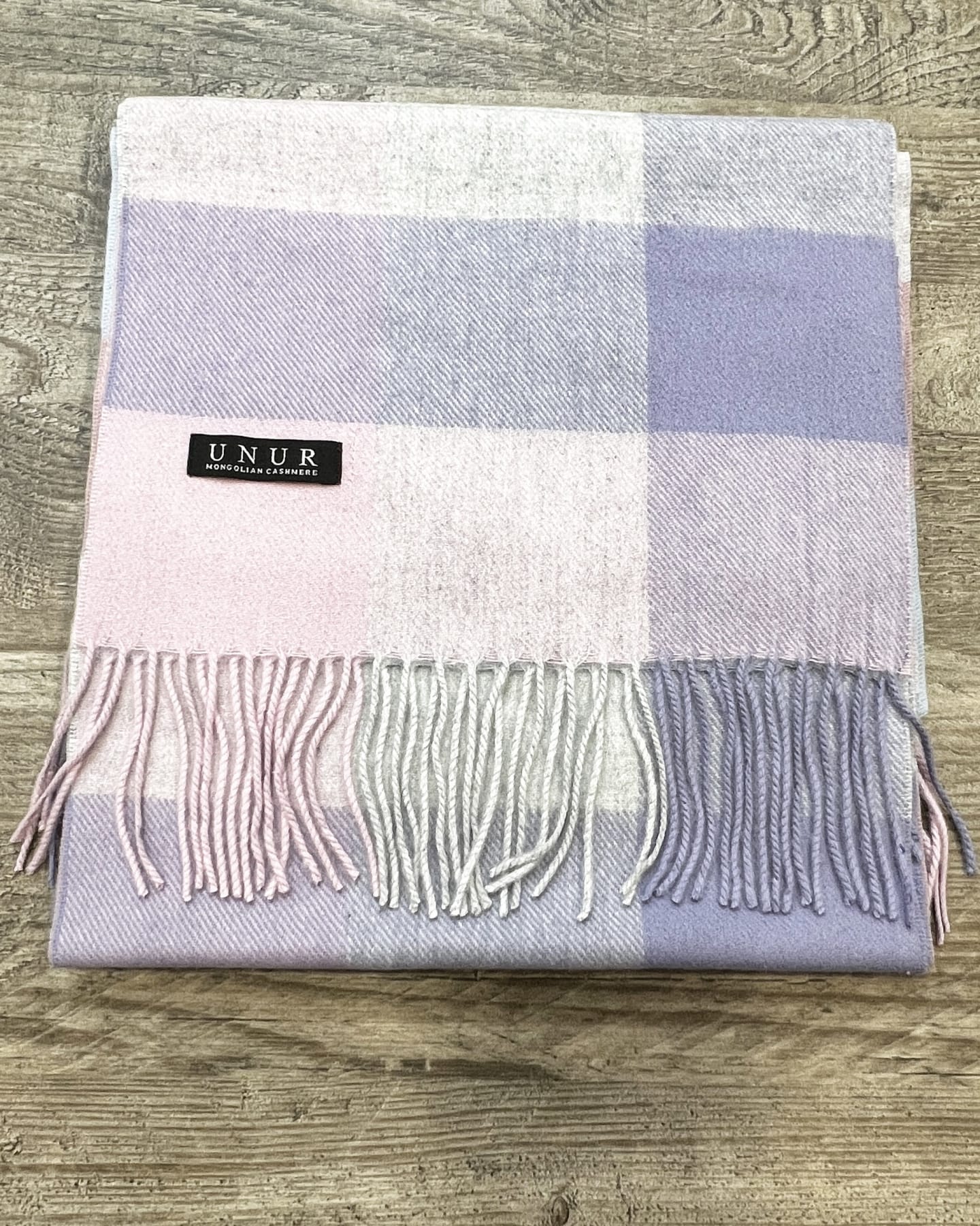 Lay-flat detail of lavender, pink and grey check Mongolian cashmere scarf with tassel fringe