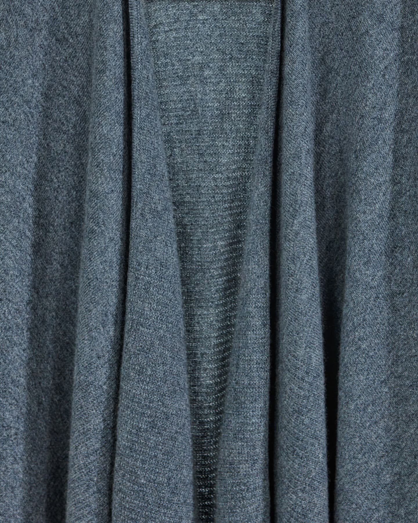 Close-up of soft cashmere poncho in dark grey