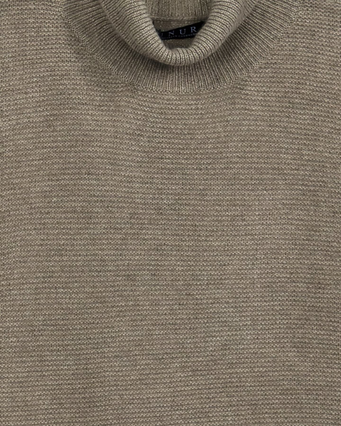 Close-up detail of the Natural Brown cashmere jumper showing the basket-weave cable-knit texture on the outer sleeve