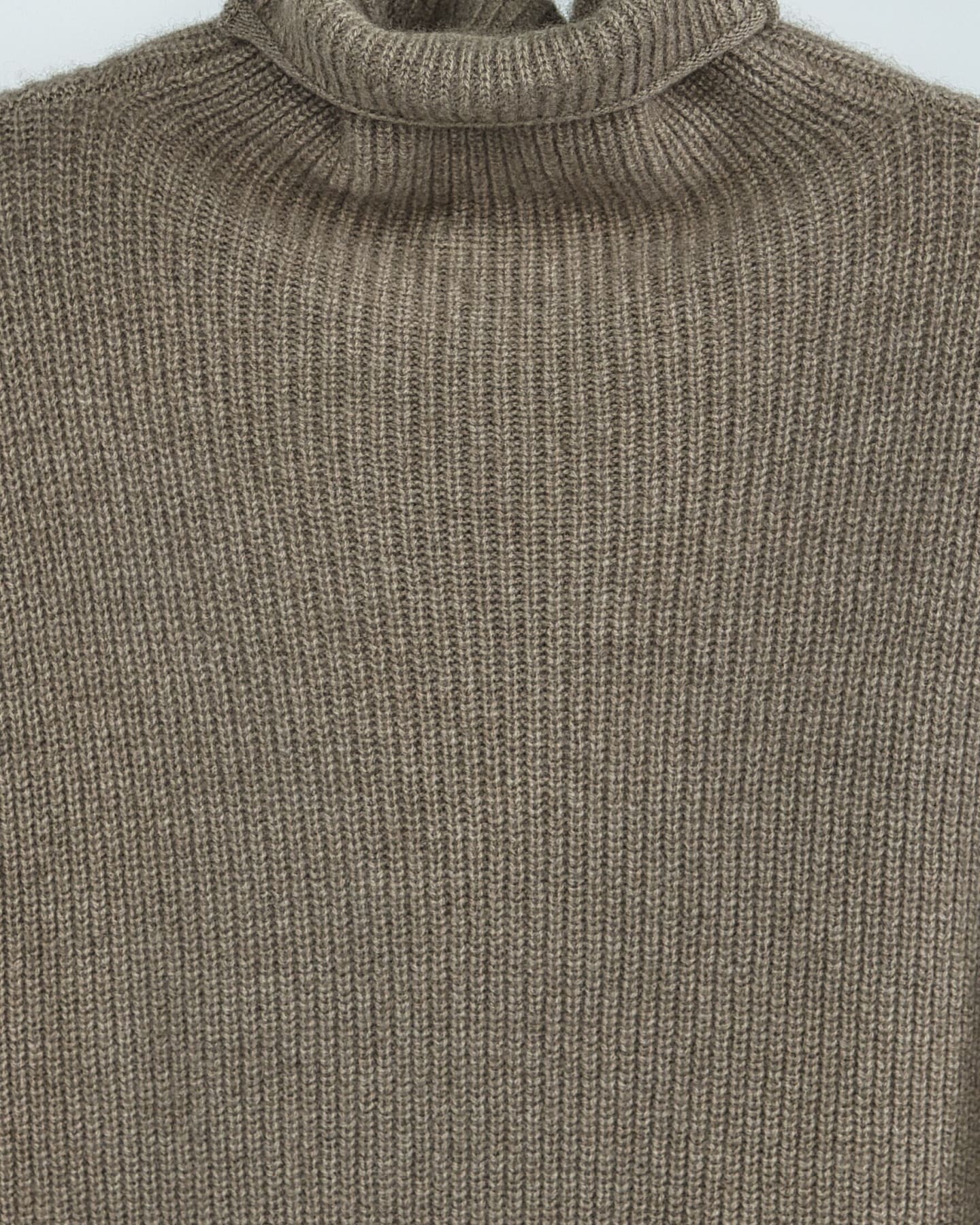 Close-up of soft cashmere ribbed jumper in natural brown