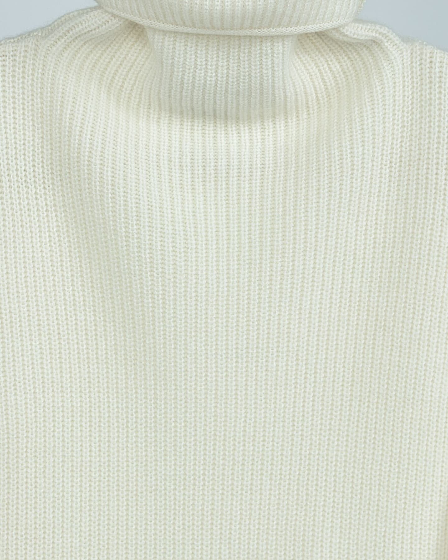 Close-up of soft cashmere ribbed jumper in white