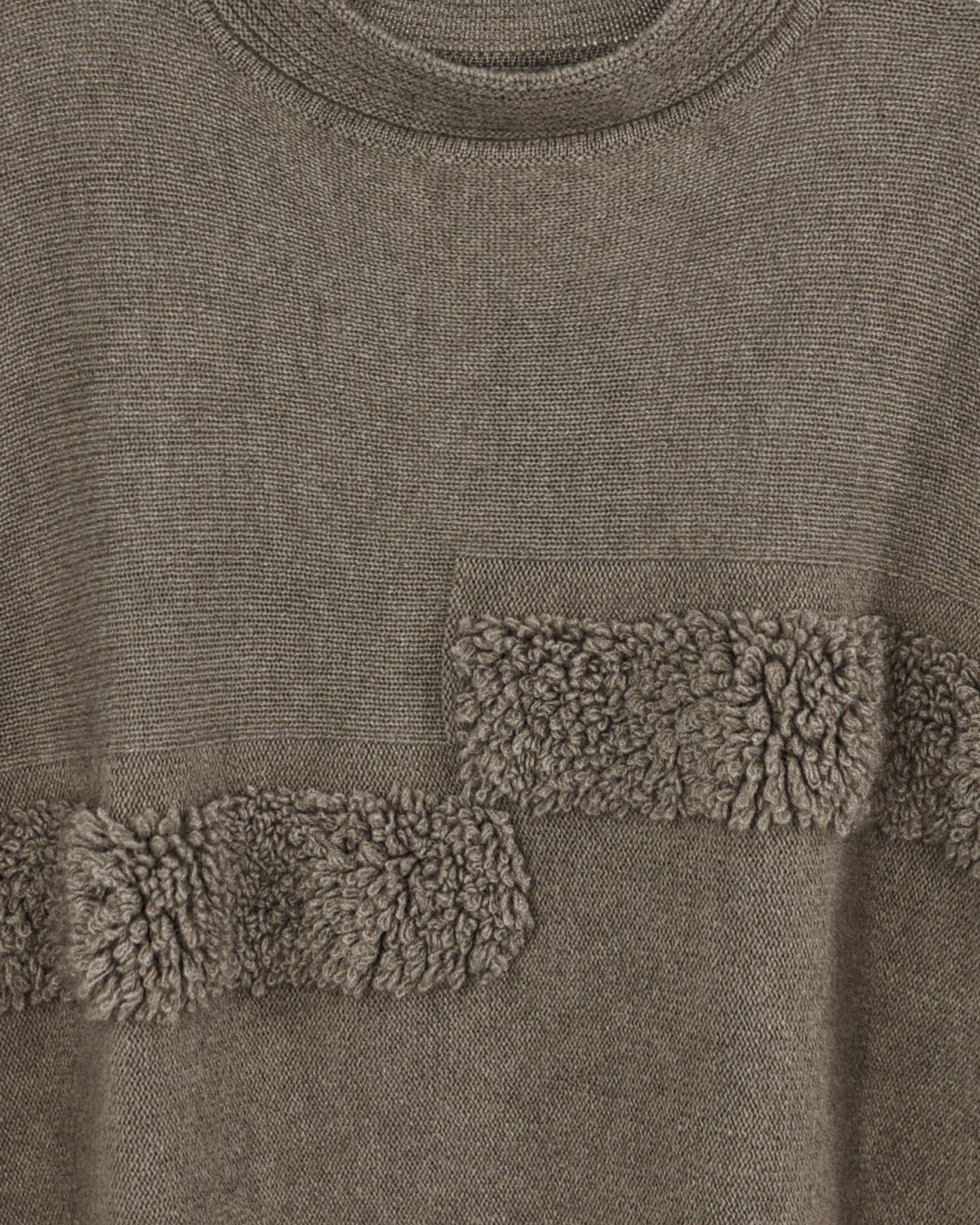 Close-up of natural brown cashmere cape top showing soft boucle texture
